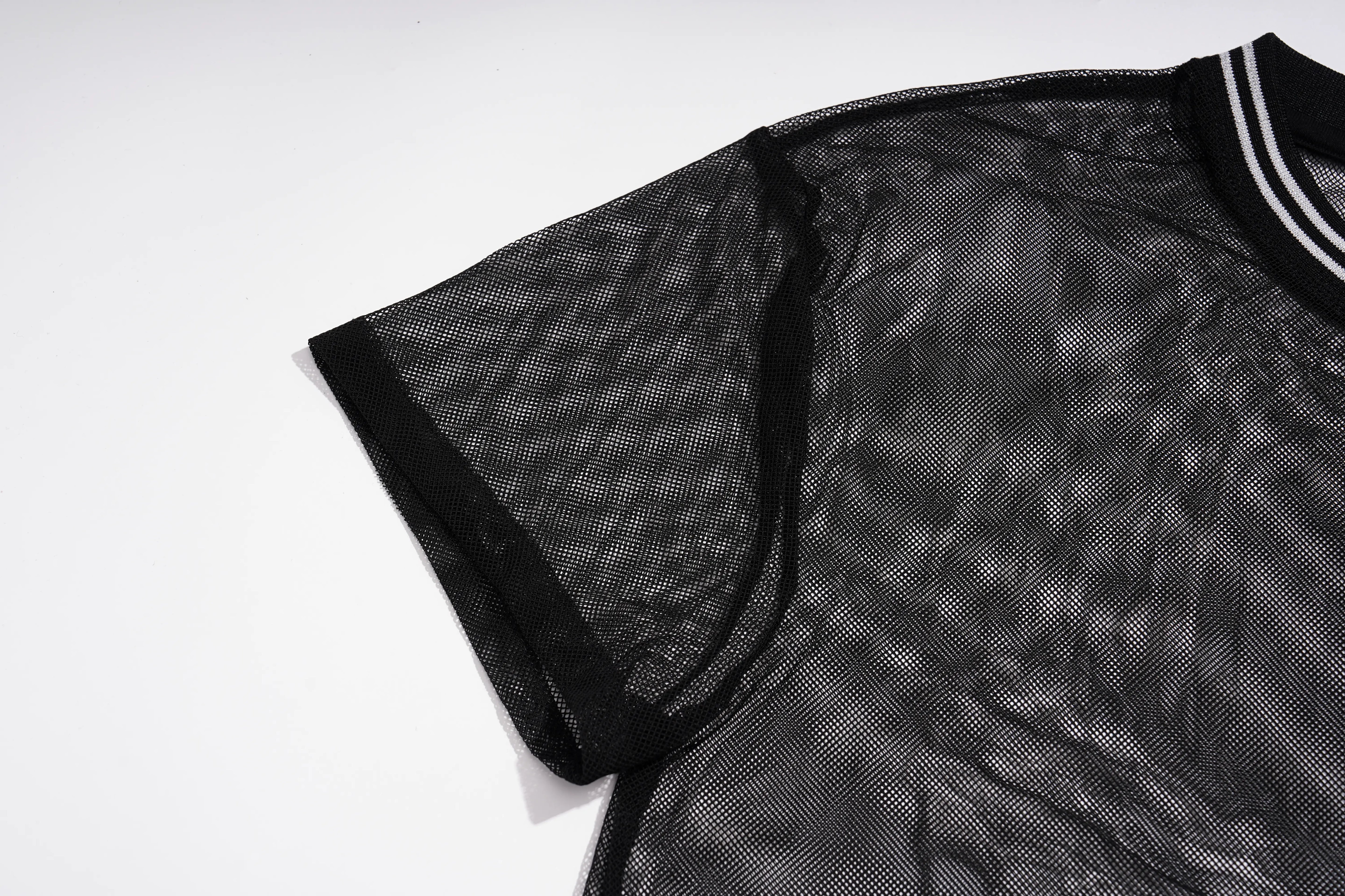 A close-up of a black short-sleeve mesh top with a black collar featuring white stripes, laid flat on a white background. TCH Rhinestone Deer Graphic Mesh Sleeve Black Streetwear T-Shirt