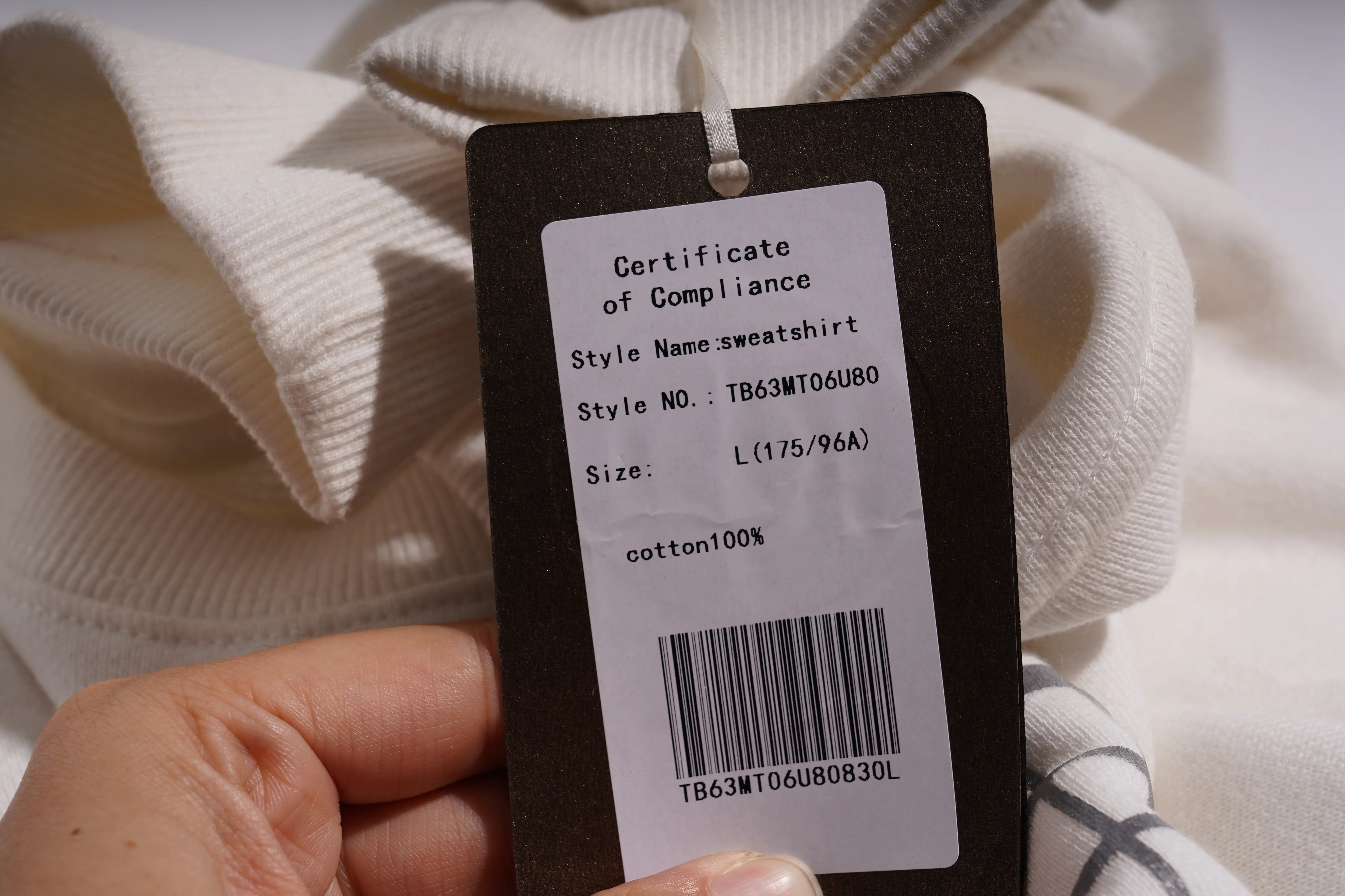 Clothing tag with product details on a white sweater, TCH Rhinestone Elephant Graphic Crew Neck Sweatshirt