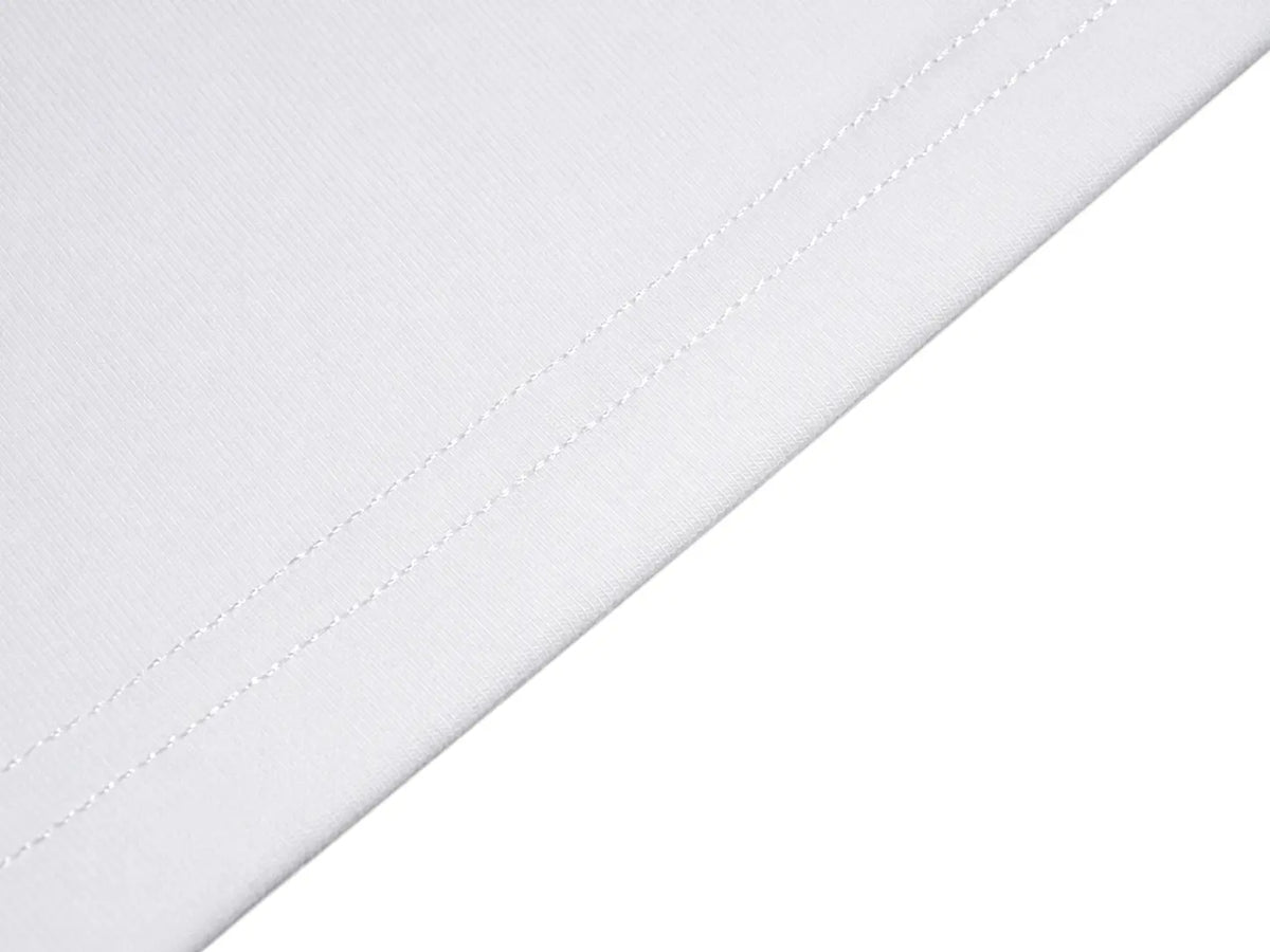 Close-up of a white textile surface with a diagonal fold and fine stitching on a white background. TCH Rhinestone Fantasy Unicorn Graphic Long Sleeve T-Shirt