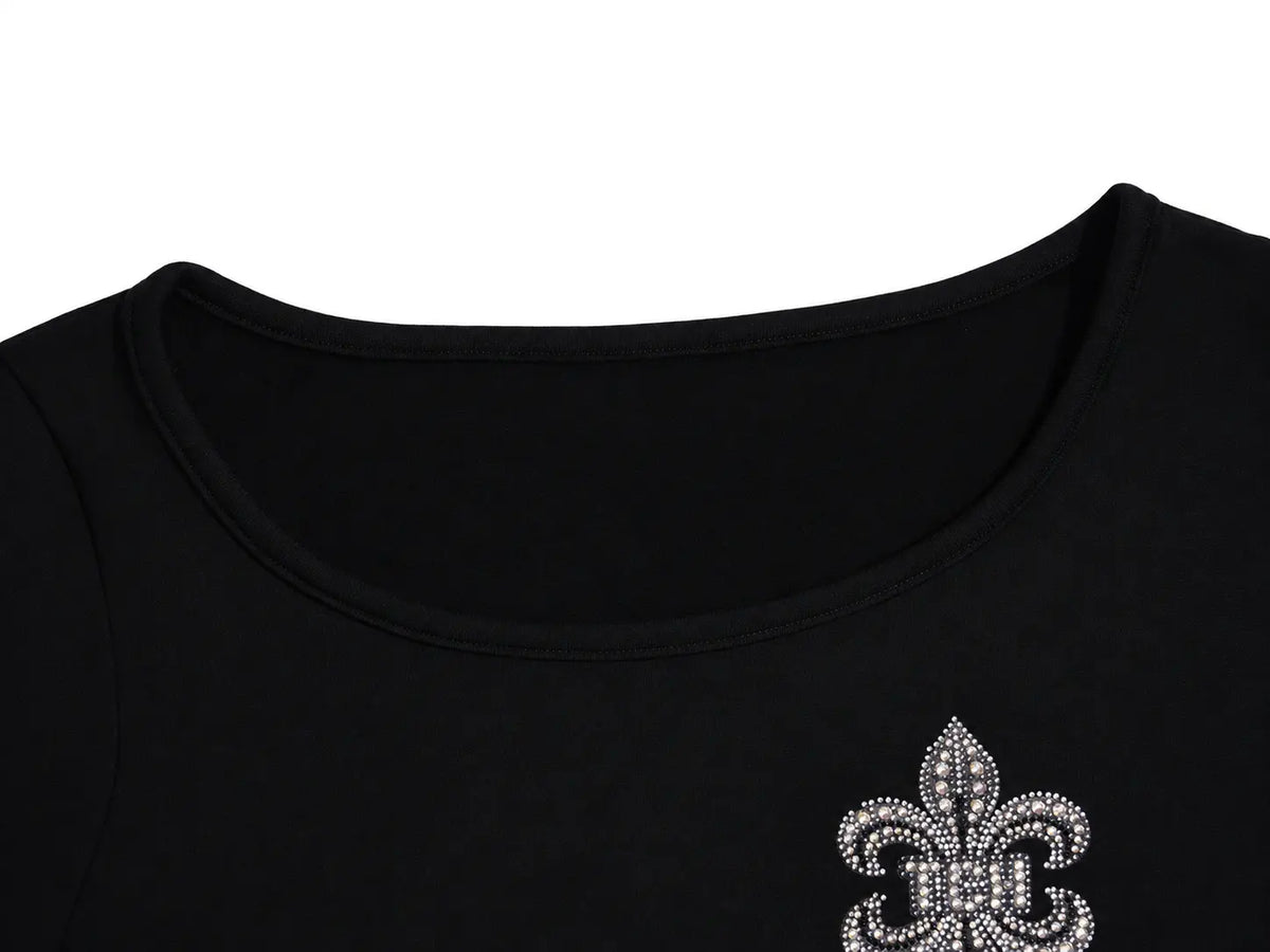 Close-up of a black scoop-neck top featuring a silver rhinestone fleur-de-lis emblem on the left chest, set against a plain white background. TCH Rhinestone Fleur-de-Lis Fitted Long Sleeve Top