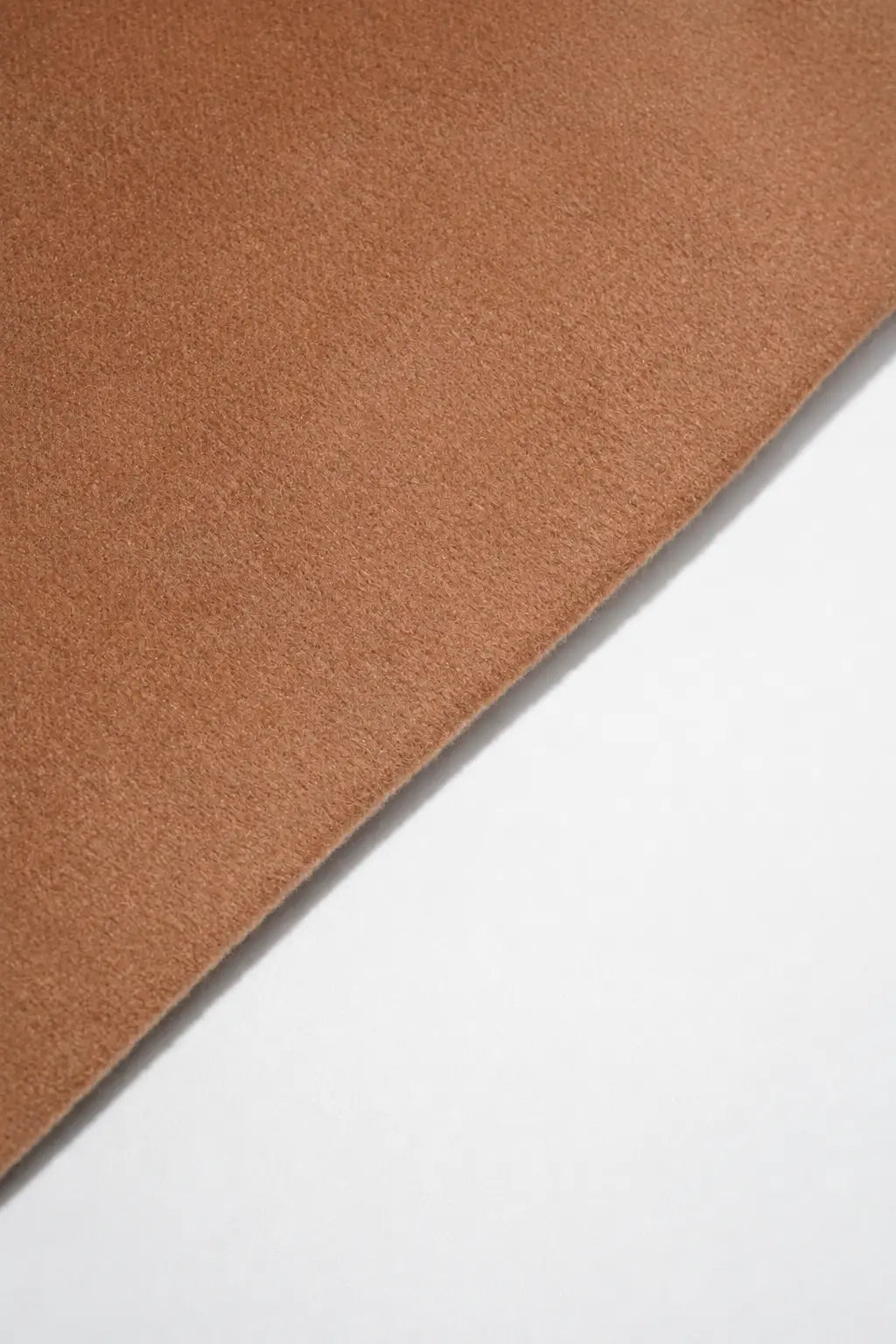 A close-up of a brown suede or microfiber fabric sheet with a diagonal cut, showing its soft texture against a plain white background. TCH Rhinestone Fleur-de-Lis Hooded Jacket