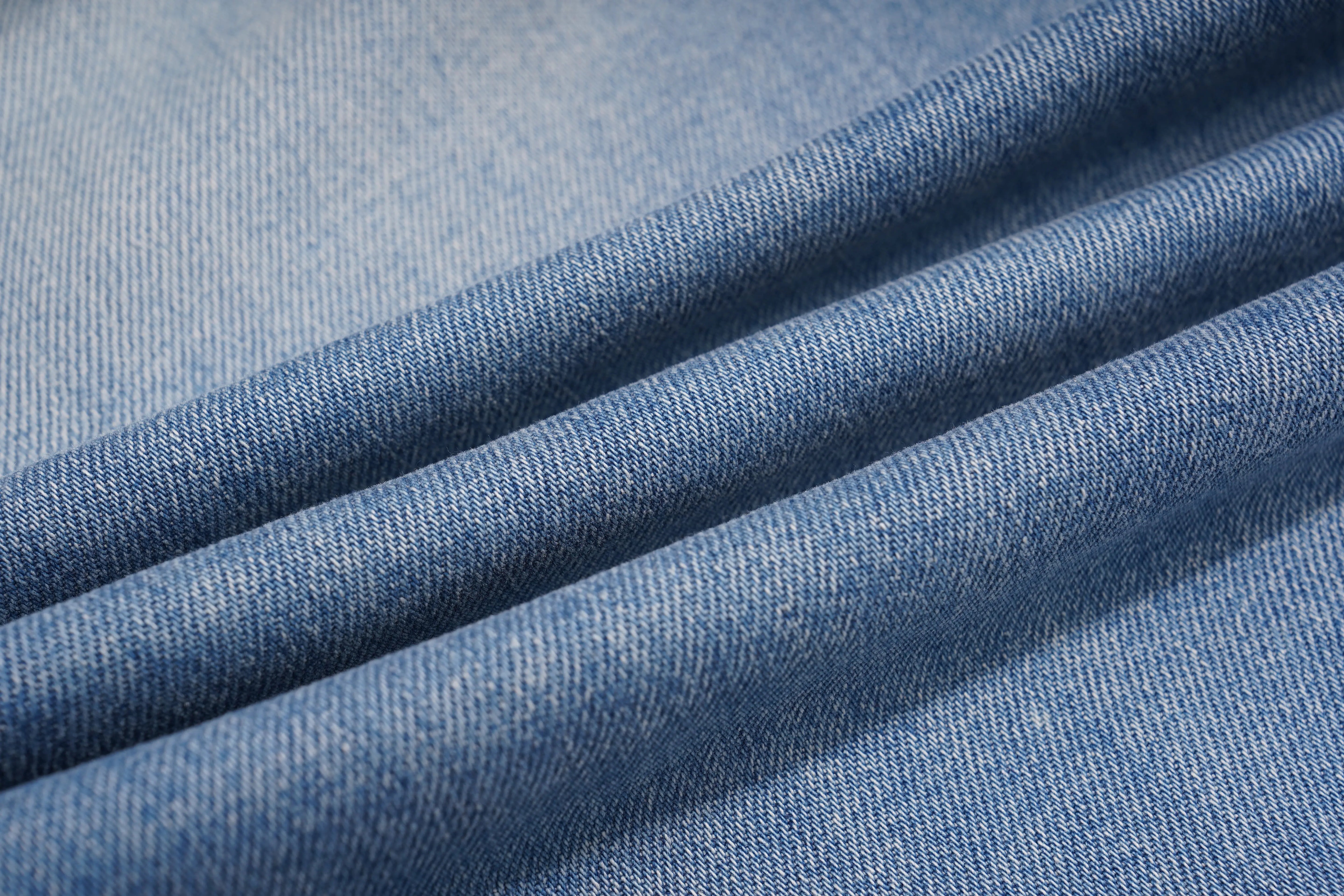 Close-up of blue denim fabric with a soft texture, TCH Rhinestone Floral Logo Wide-Leg Denim Shorts