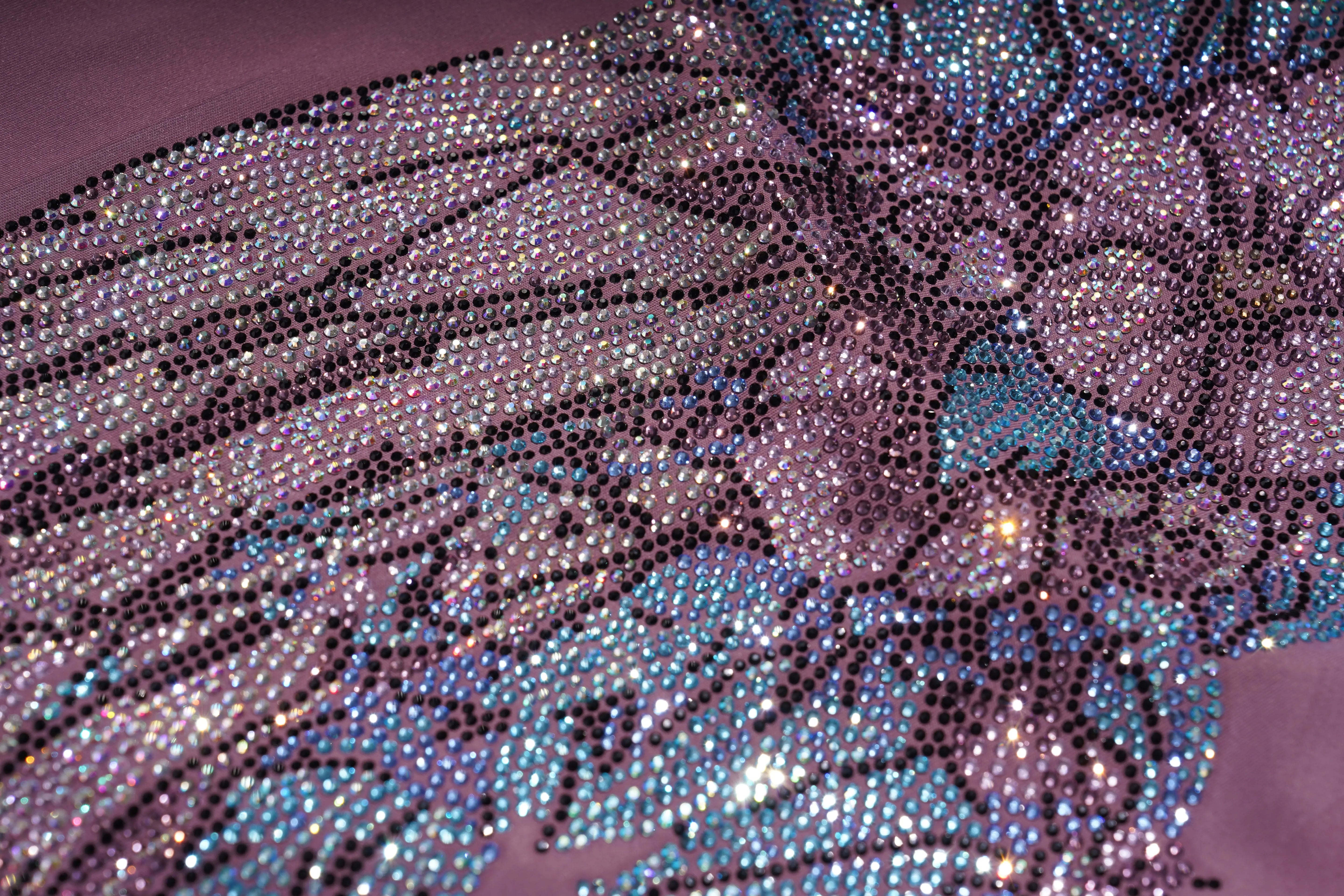 Close-up of a decorative fabric with sequins and beads on a purple background, TCH Rhinestone Floral Wing High-Waist Leggings