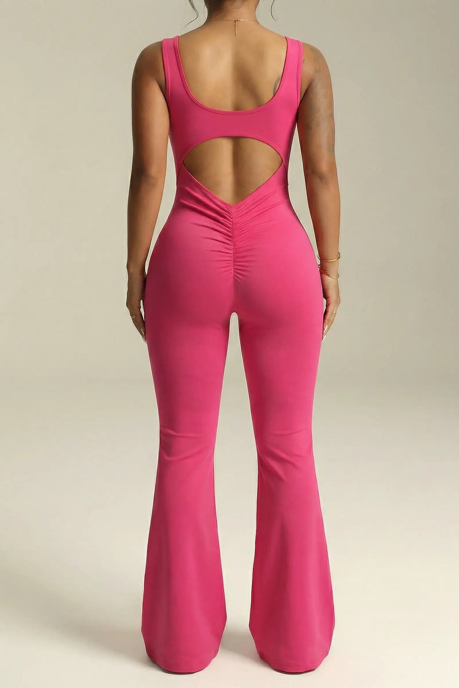 Pink jumpsuit with cut-out back on a neutral background, TCH Rhinestone Floral Wing Yoga Jumpsuit-1