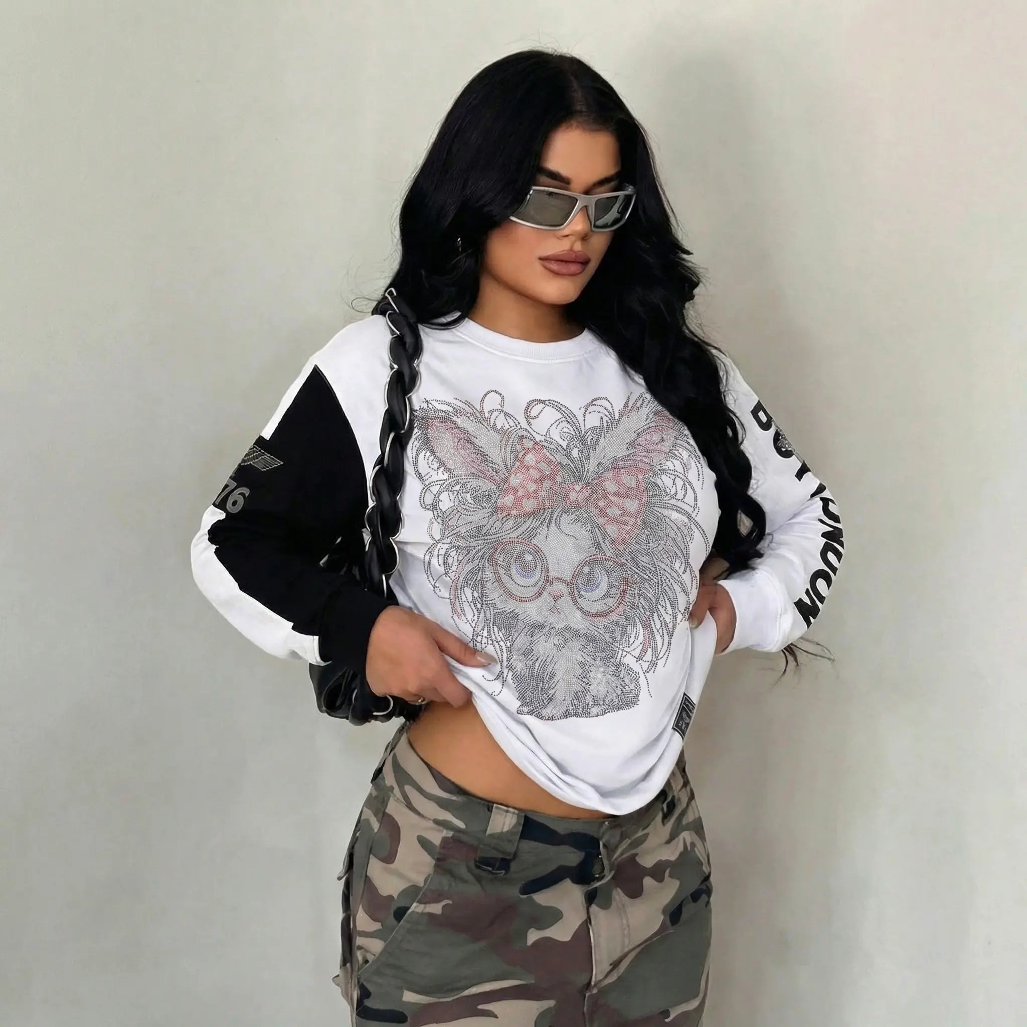 Person wearing a white sweatshirt with graphic design and camouflage pants against a plain background, TCH Rhinestone Hello Kitty BOYLONDON Sweatshirt