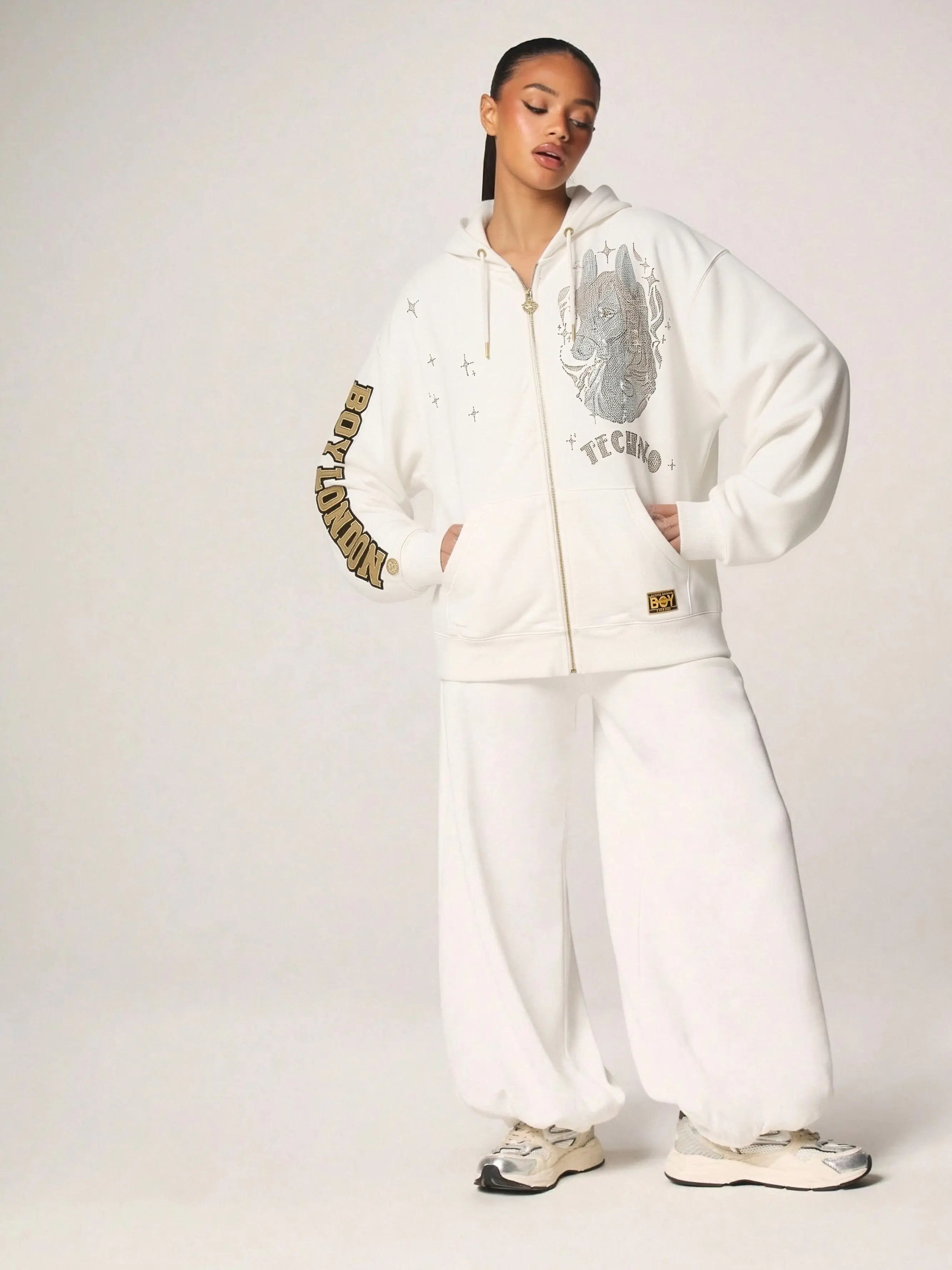 Person wearing a white tracksuit with brand logos on a plain background, TCH Rhinestone Horse Graphic Jacket