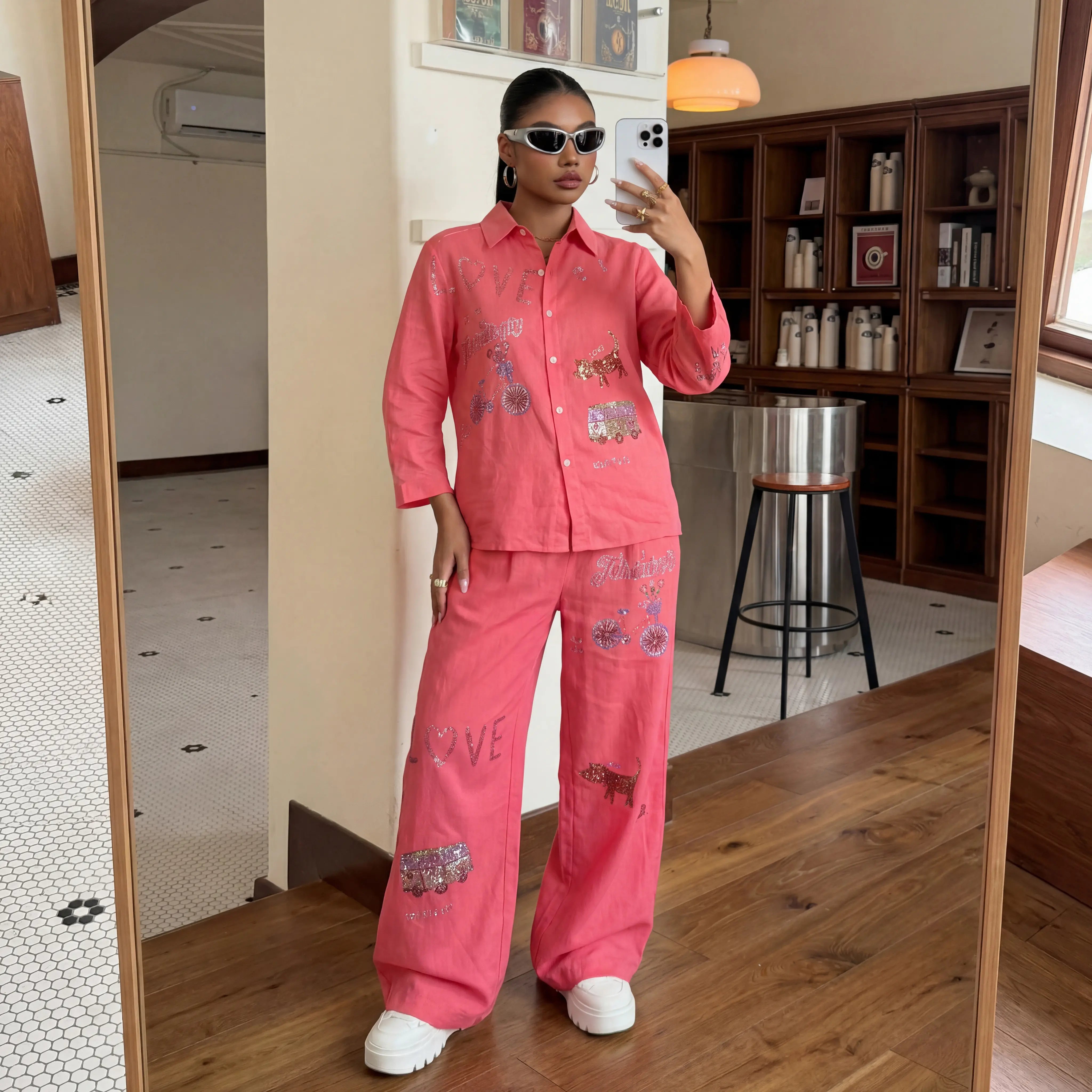 Woman taking a mirror selfie wearing a pink outfit with embroidered designs in a room. TCH Rhinestone Love Lucky Pig Set