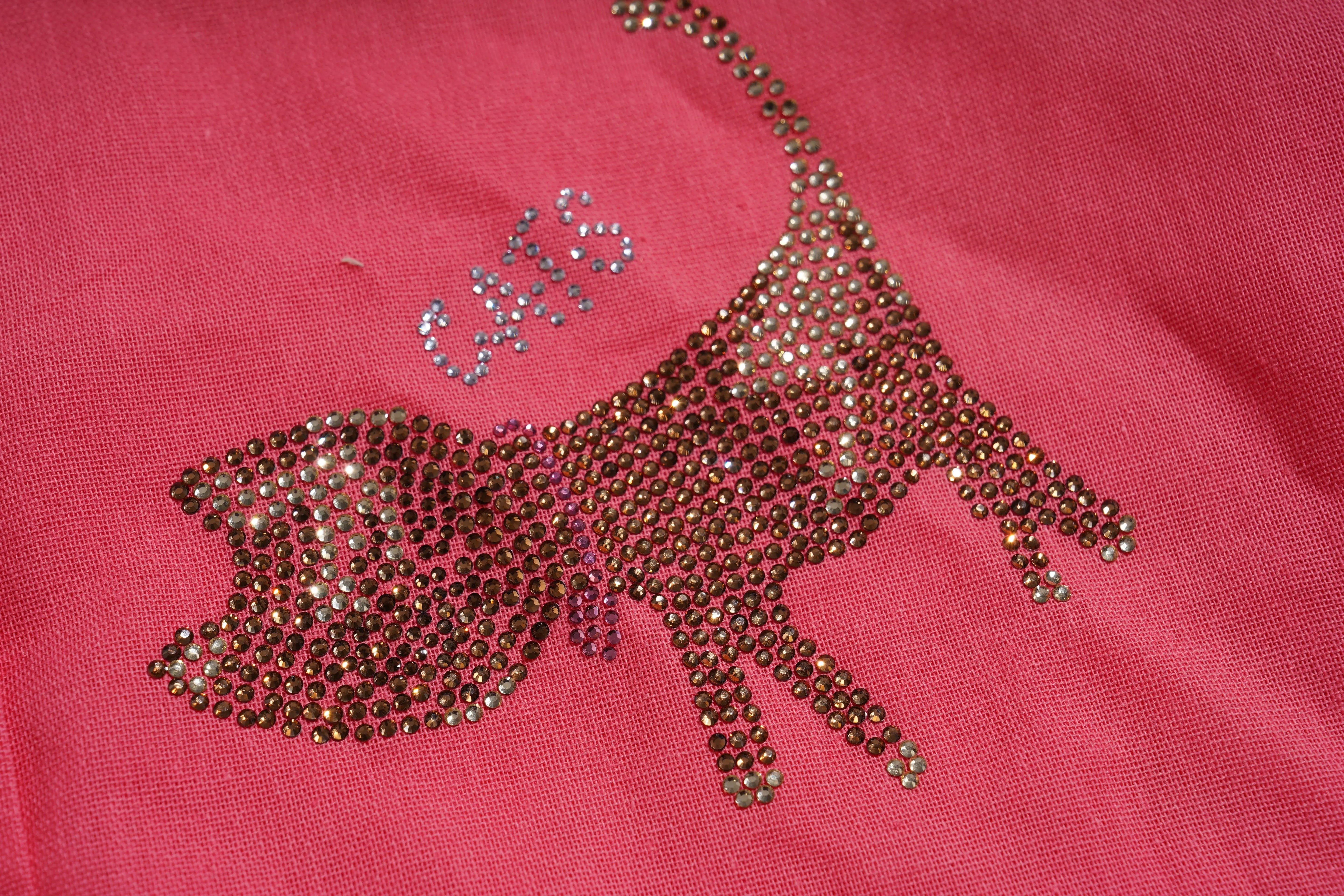 Decorative rhinestone design on a pink fabric background, TCH Rhinestone Love Lucky Pig Set