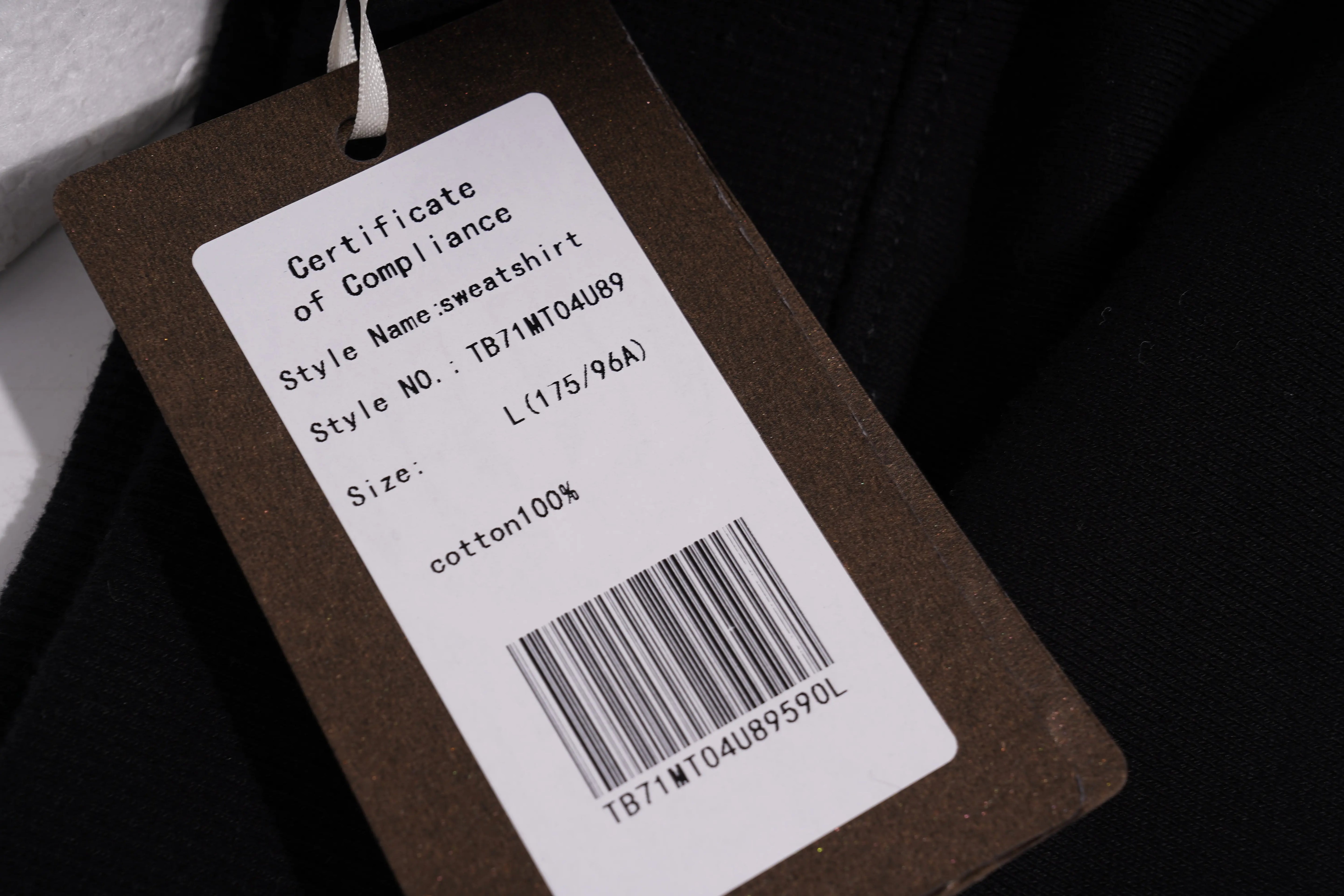 Product tag with certificate of compliance details on a dark background