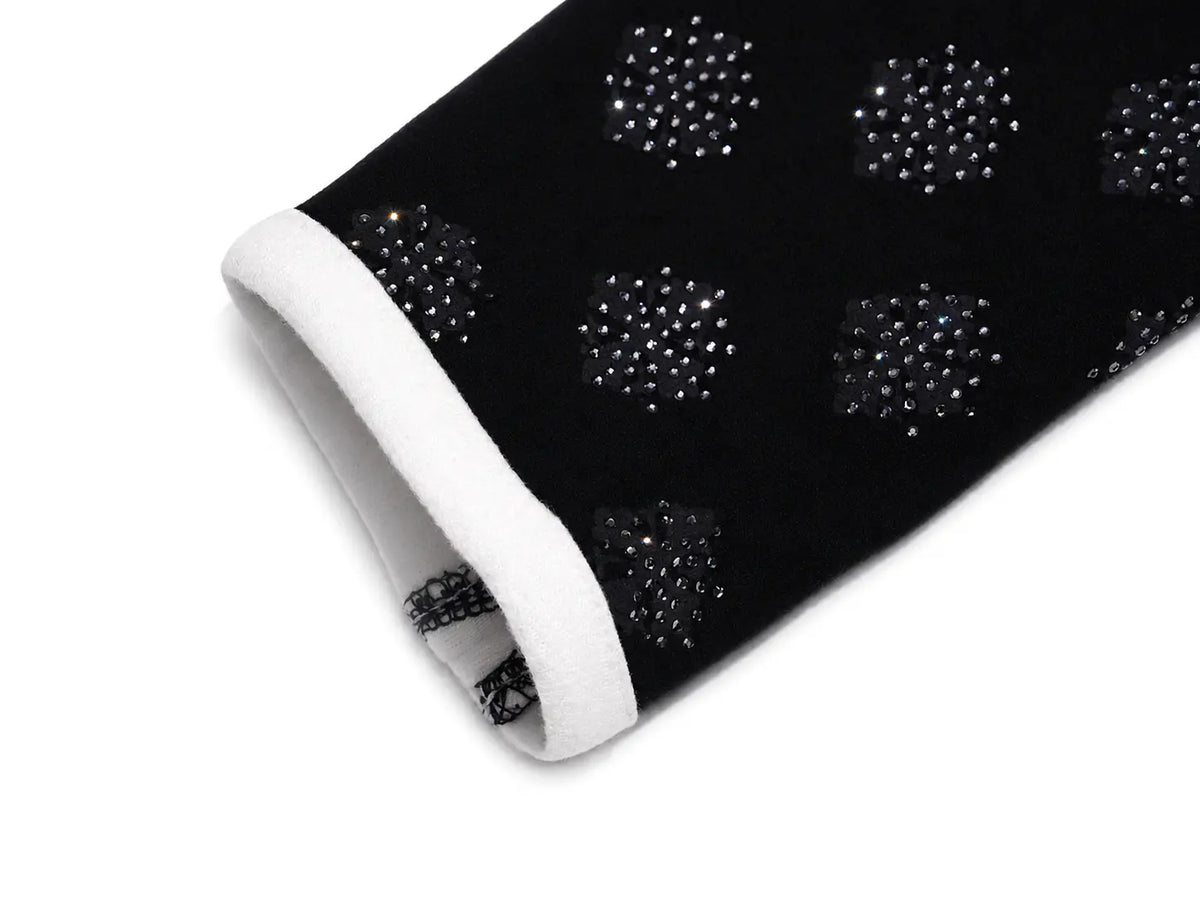 A close-up of a black sleeve or cuff featuring a pattern of sparkling rhinestone circles and a contrasting white inner lining. TCH Rhinestone Pattern Long Sleeve Top