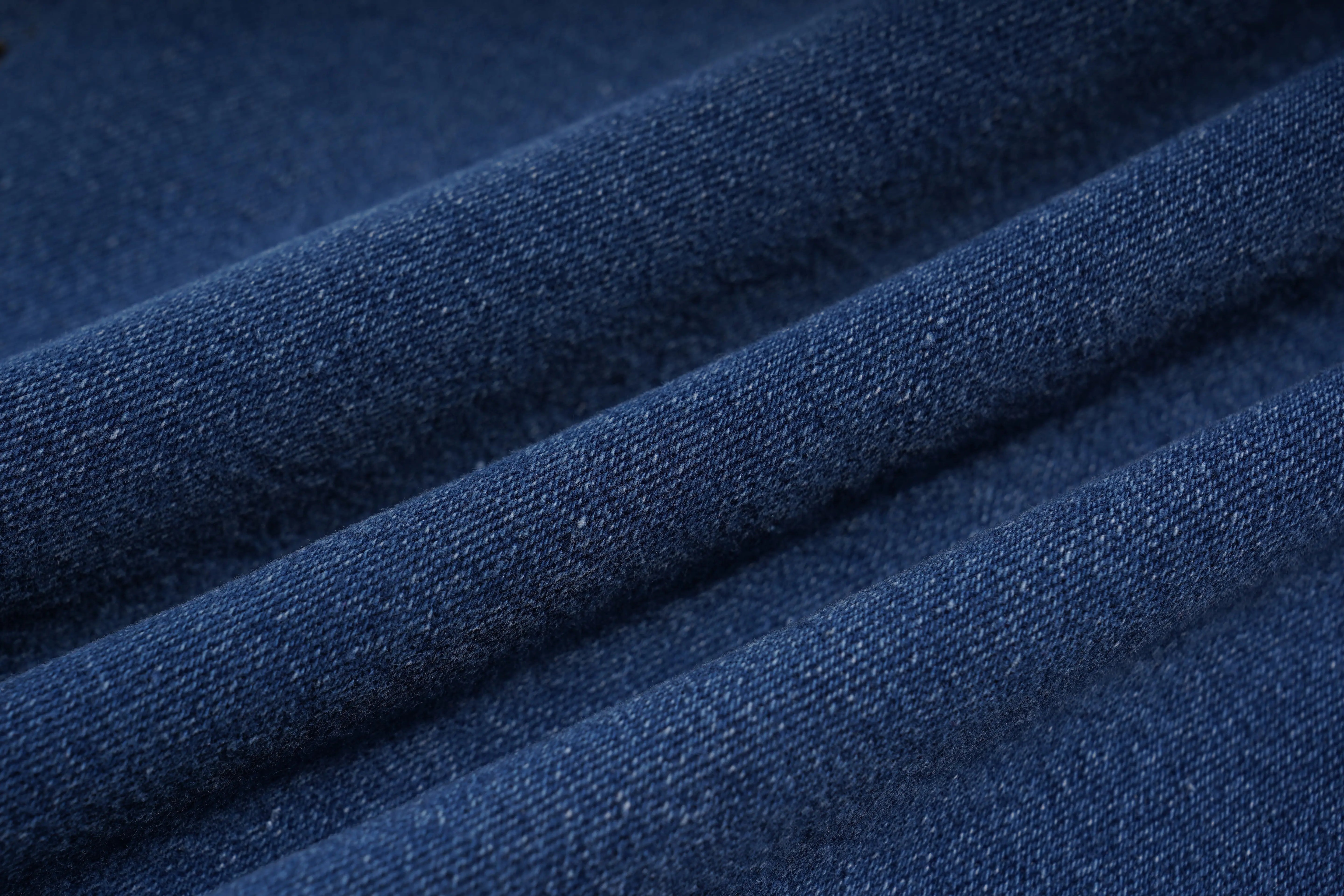 Close-up of blue denim fabric with a textured pattern, TCH Rhinestone Pendant Allover Denim Jeans