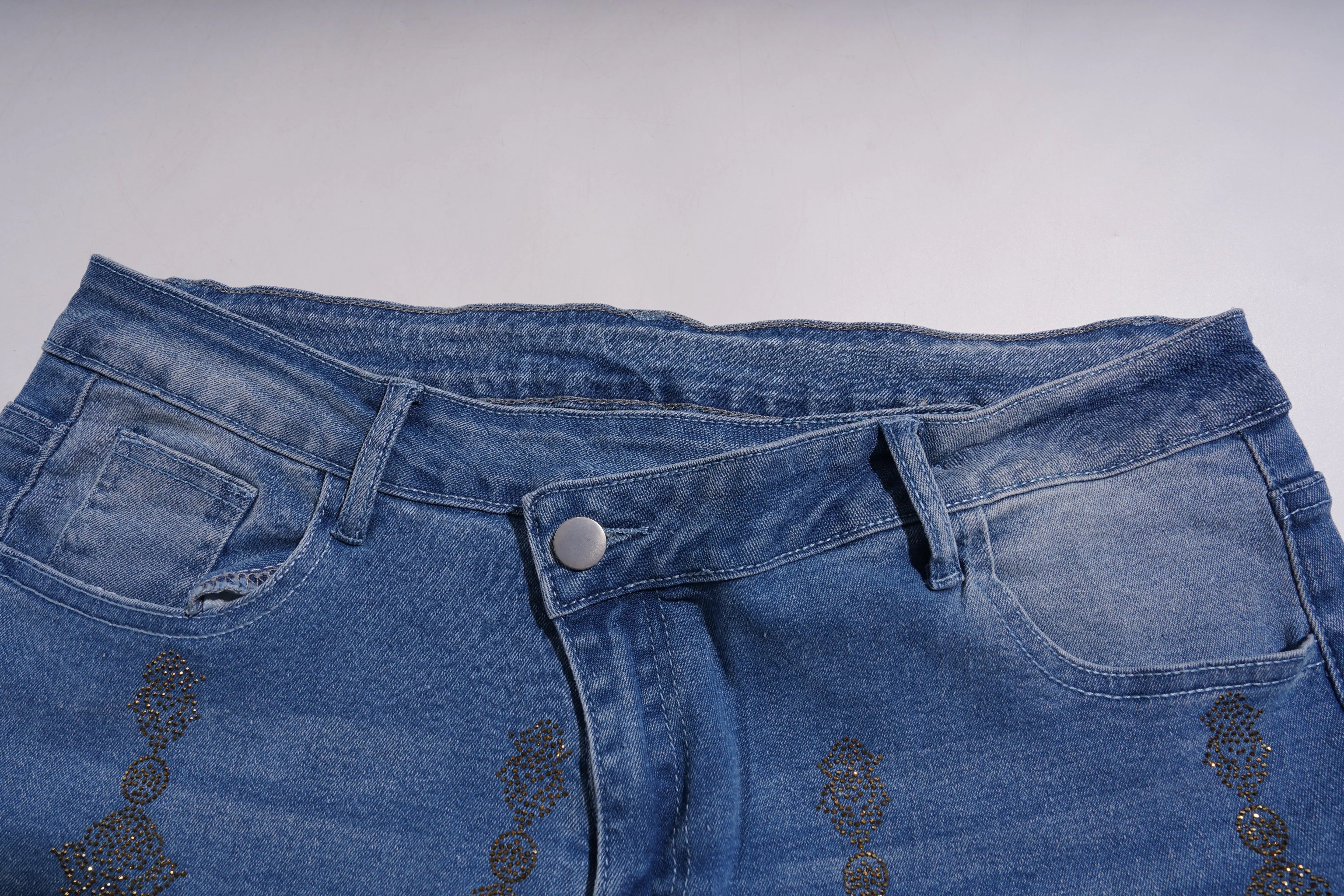Close-up of blue jeans with decorative elements on a light gray background, TCH Rhinestone Pendant Allover Denim Jeans