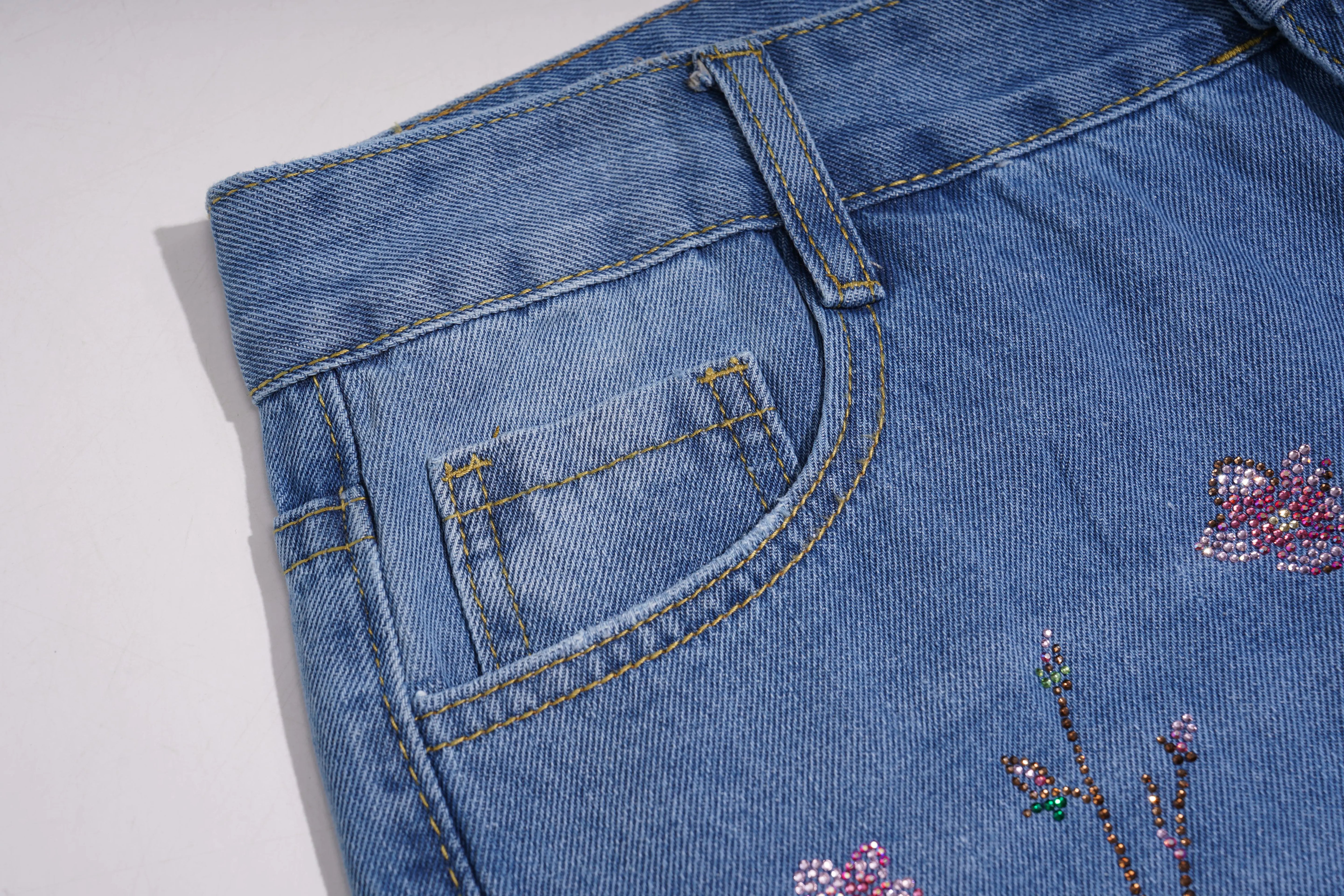 Red fabric with silver sequin patterns, TCH Rhinestone Plum Blossom Tree Distressed Denim Jeans