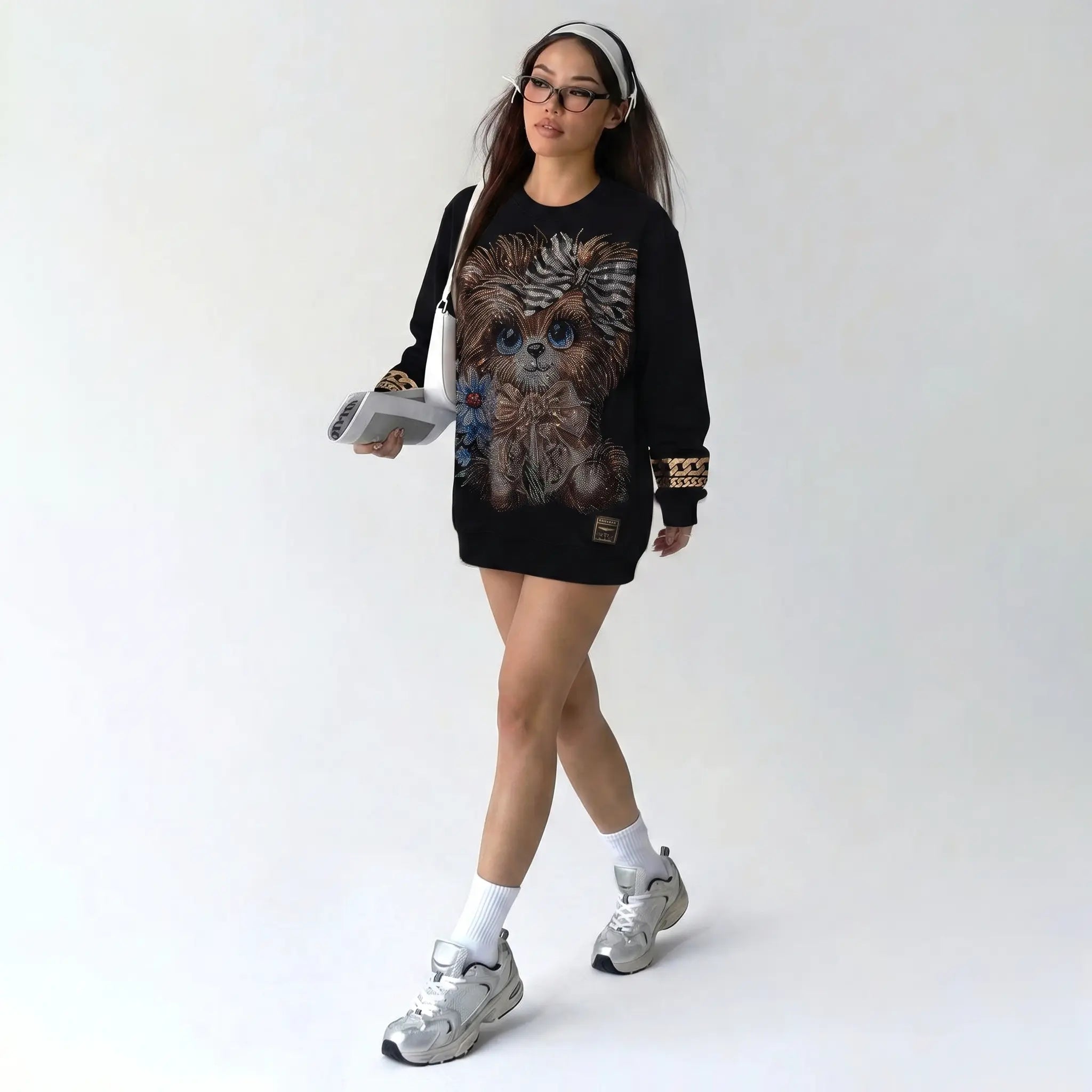 Person wearing a black sweatshirt with a graphic design, holding a magazine, on a white background, TCH Rhinestone Puppy Black Streetwear Sweatshirt