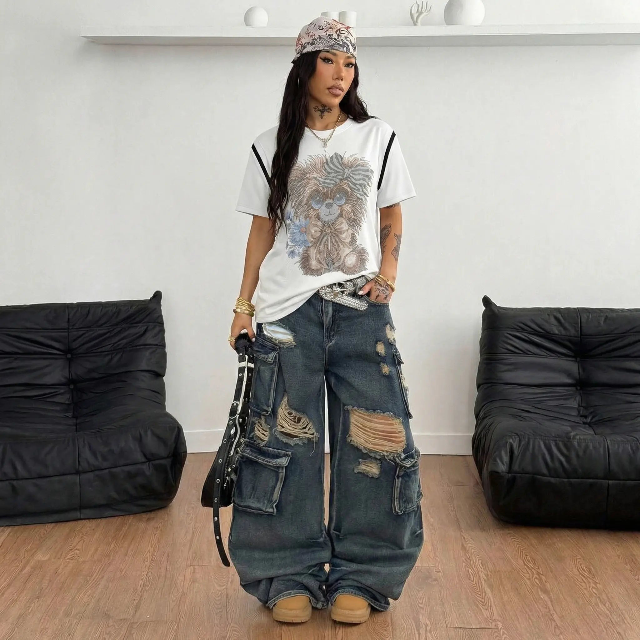 Person wearing a white t-shirt with a graphic design and ripped jeans in a minimalistic room. TCH Rhinestone Puppy Bow White T-Shirt-1 7