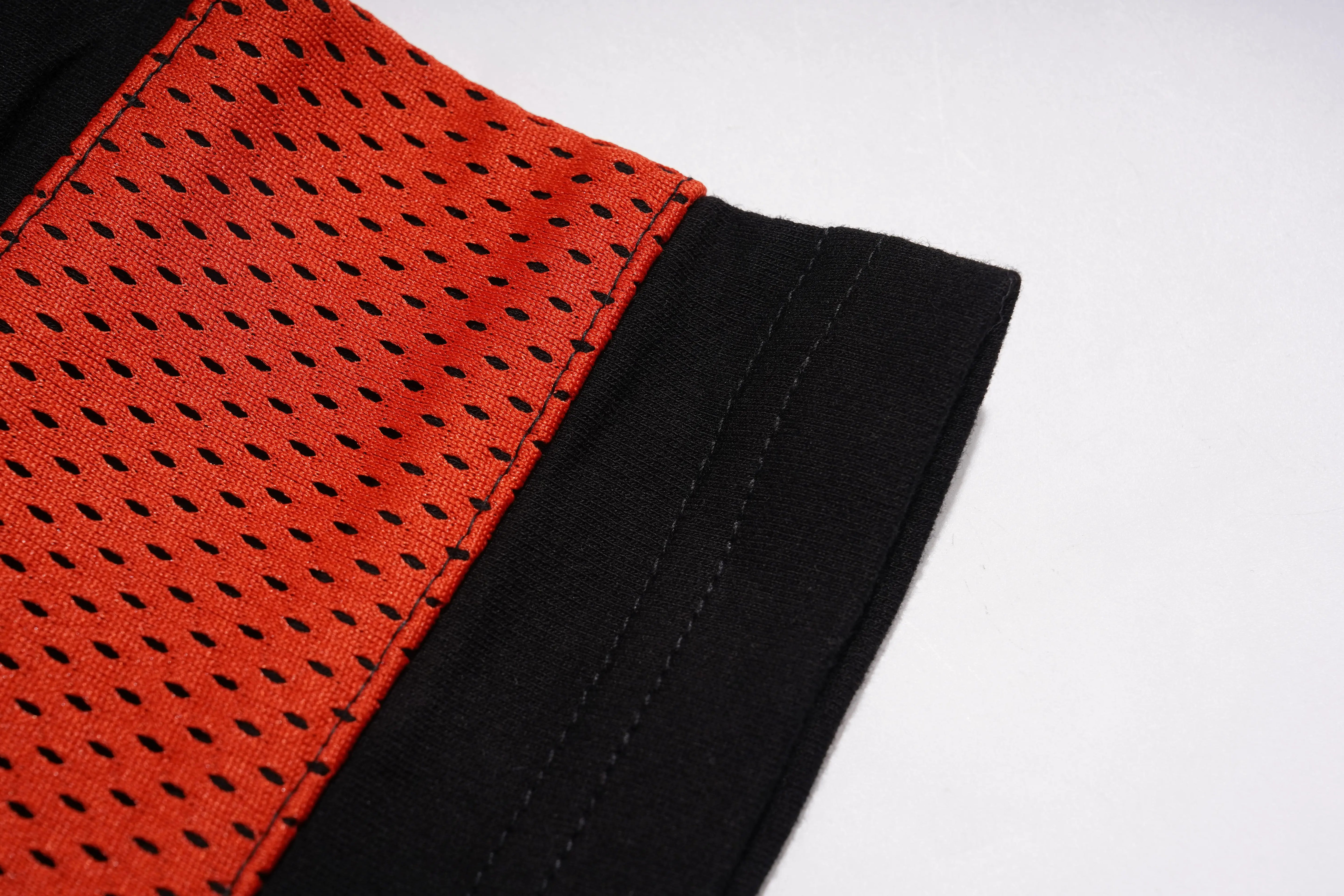 Close-up of red and black textured fabric on a white background, TCH Rhinestone Rabbit Black Red Jersey