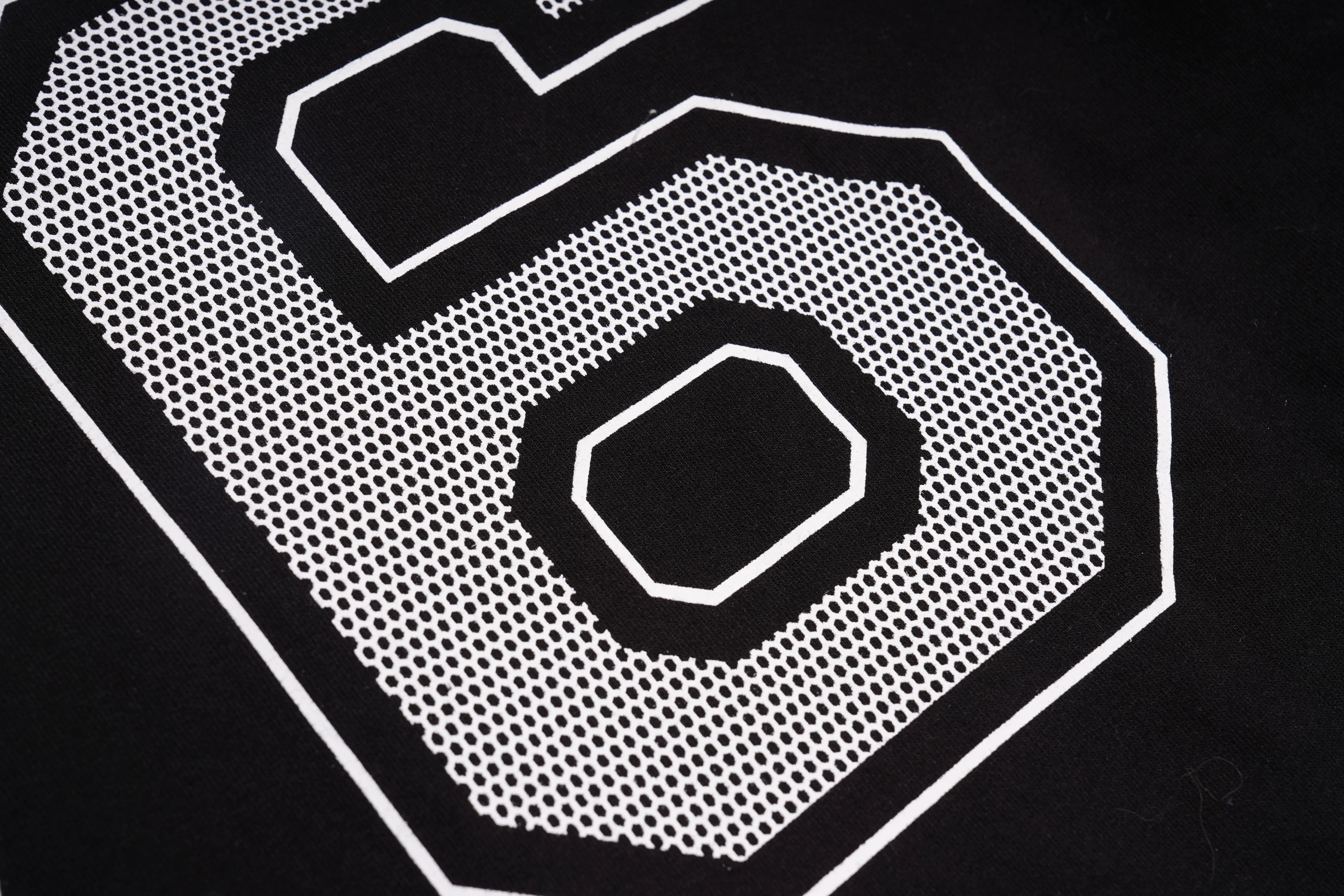 Close-up of a white geometric pattern on a black background, TCH Rhinestone Rabbit Black Red Jersey