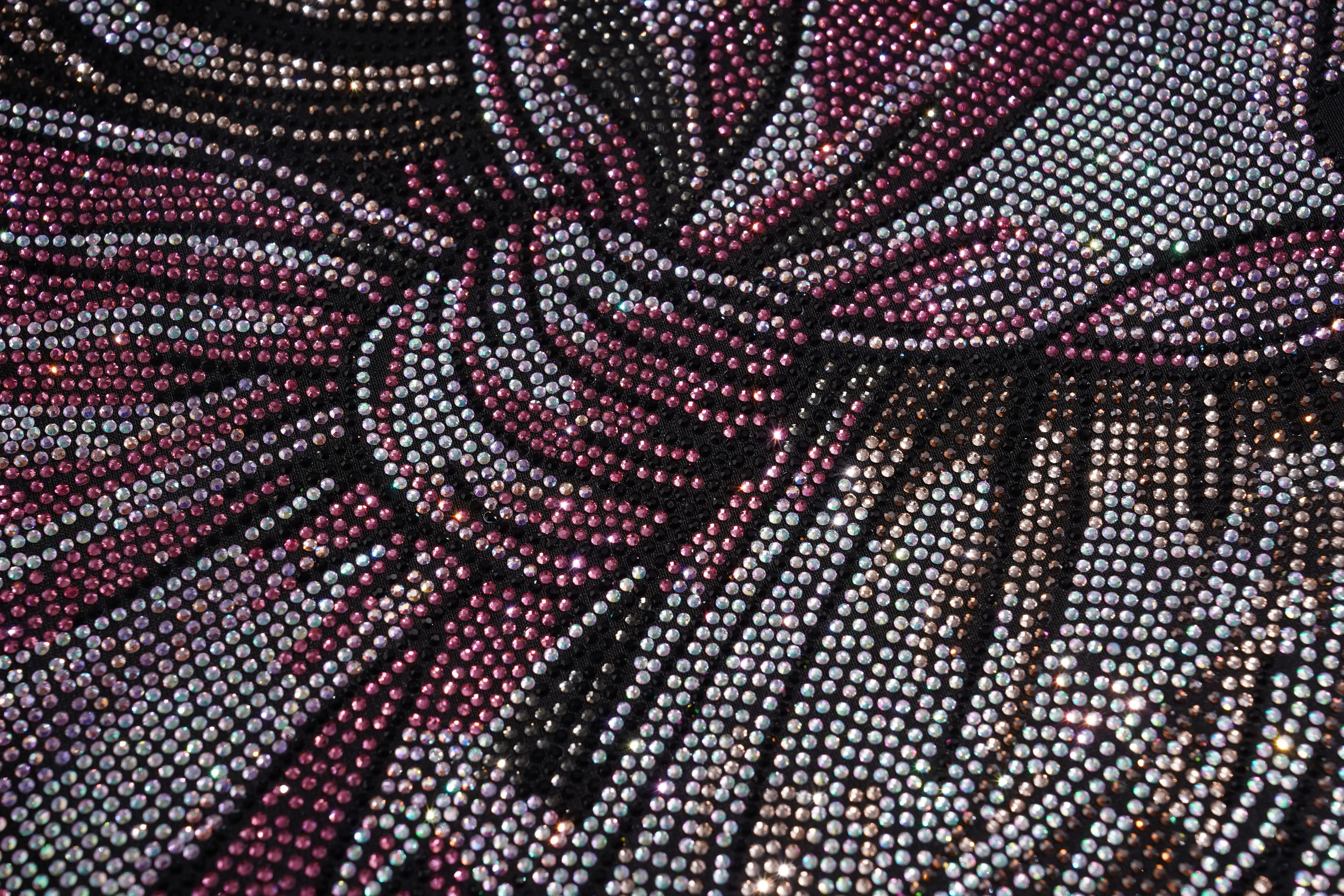 Close-up of a beaded fabric with intricate pattern, TCH Rhinestone Rabbit Black Red Jersey