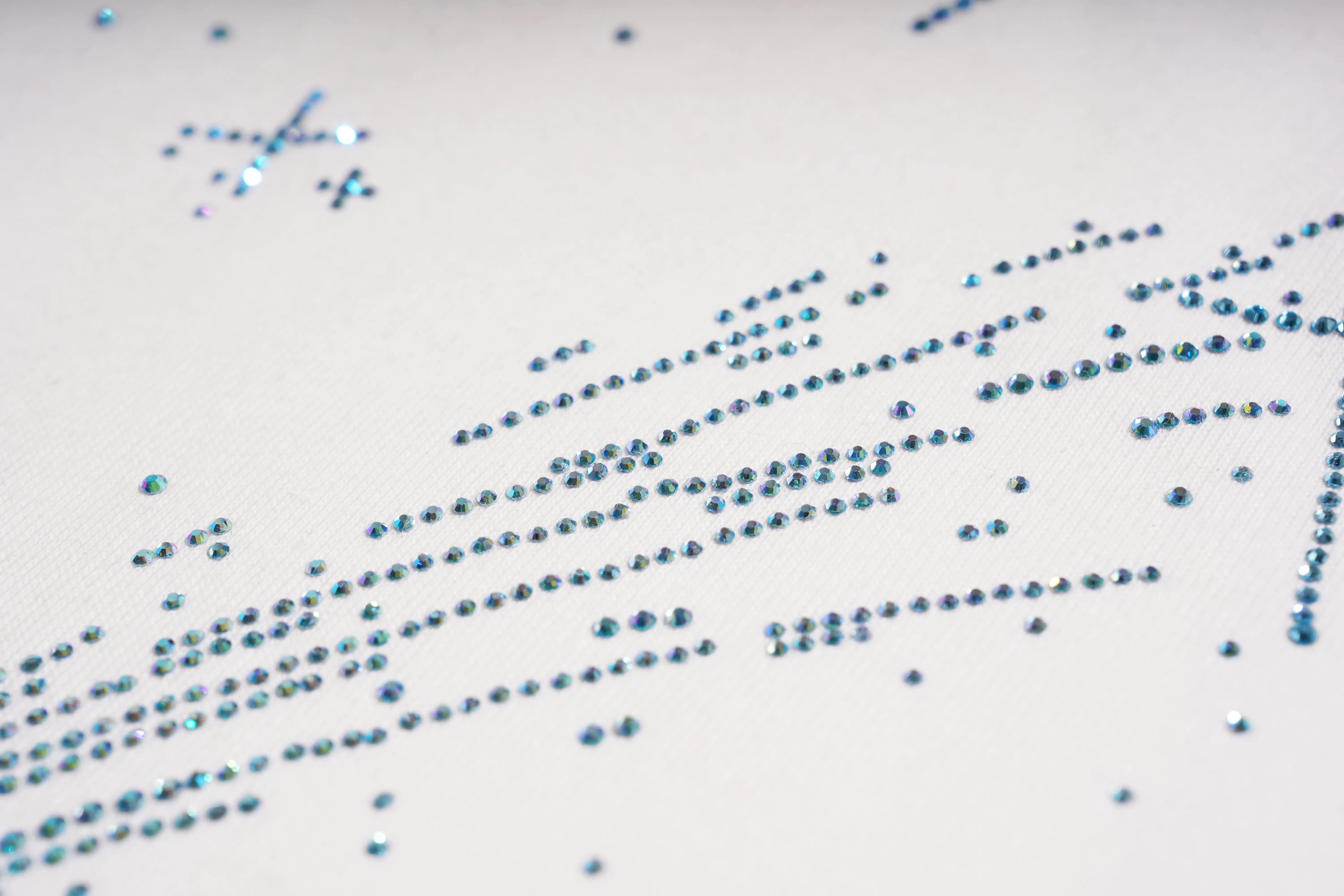 Close-up of blue rhinestones on a white fabric background TCH Rhinestone Shooting Star Sweatshirt-