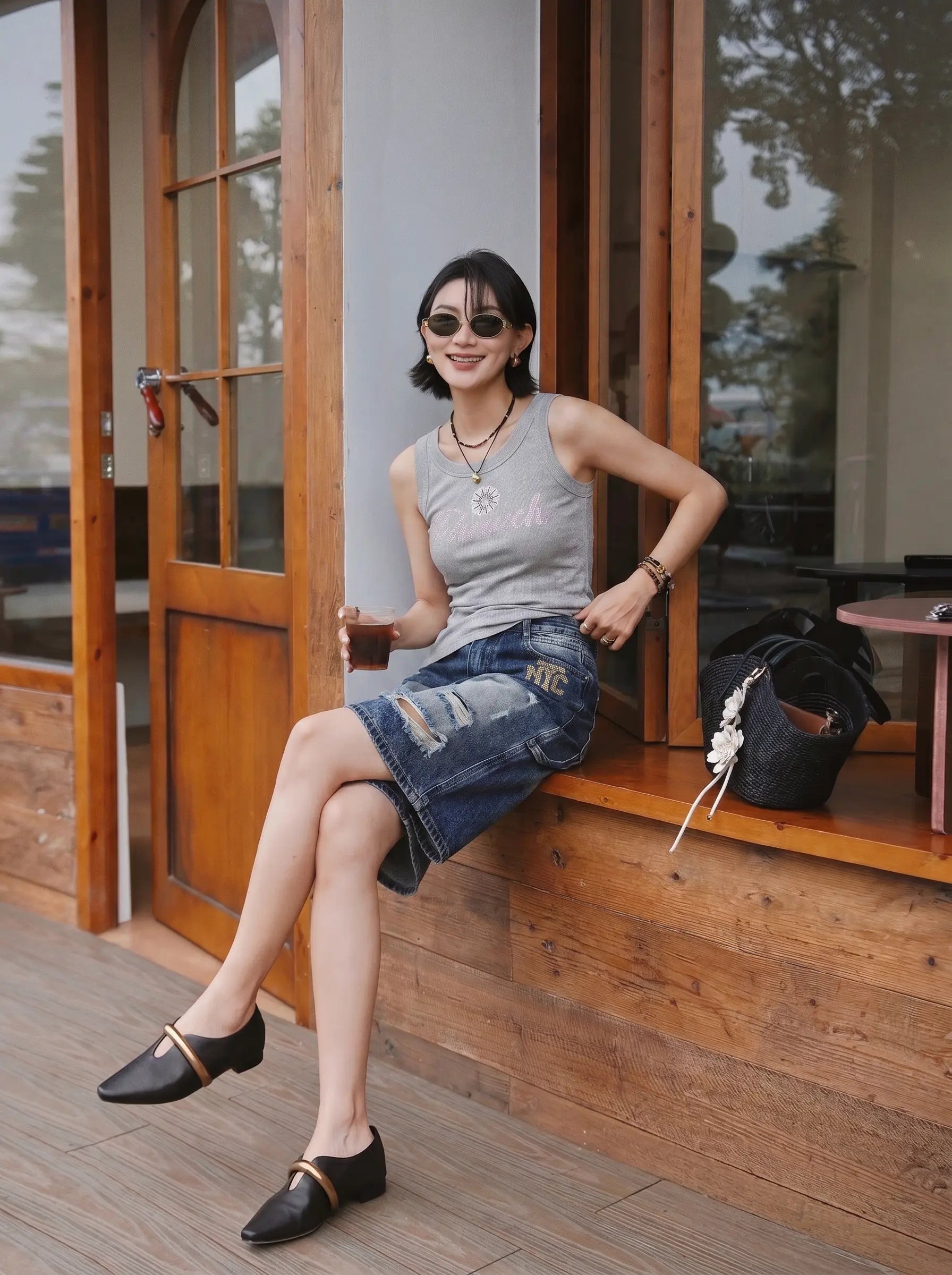 Woman sitting on a wooden bench wearing sunglasses and casual clothing. TCH Rhinestone Signature Ribbed Tank Top