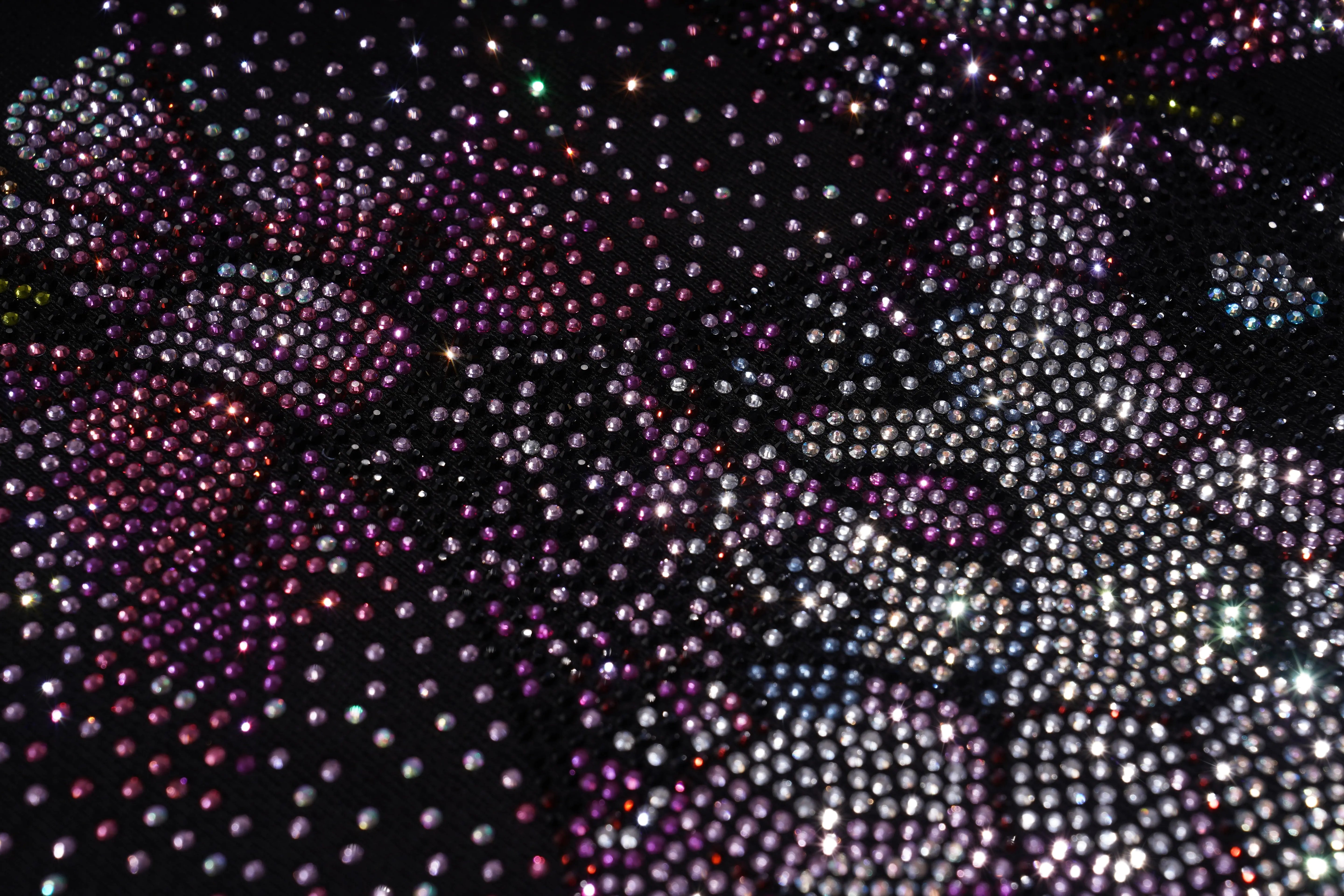 Close-up of a textured surface with multicolored beads or crystals. TCH Rhinestone Snake Eagle Sweatshirt Luxury Streetwear Brand Official Showcase