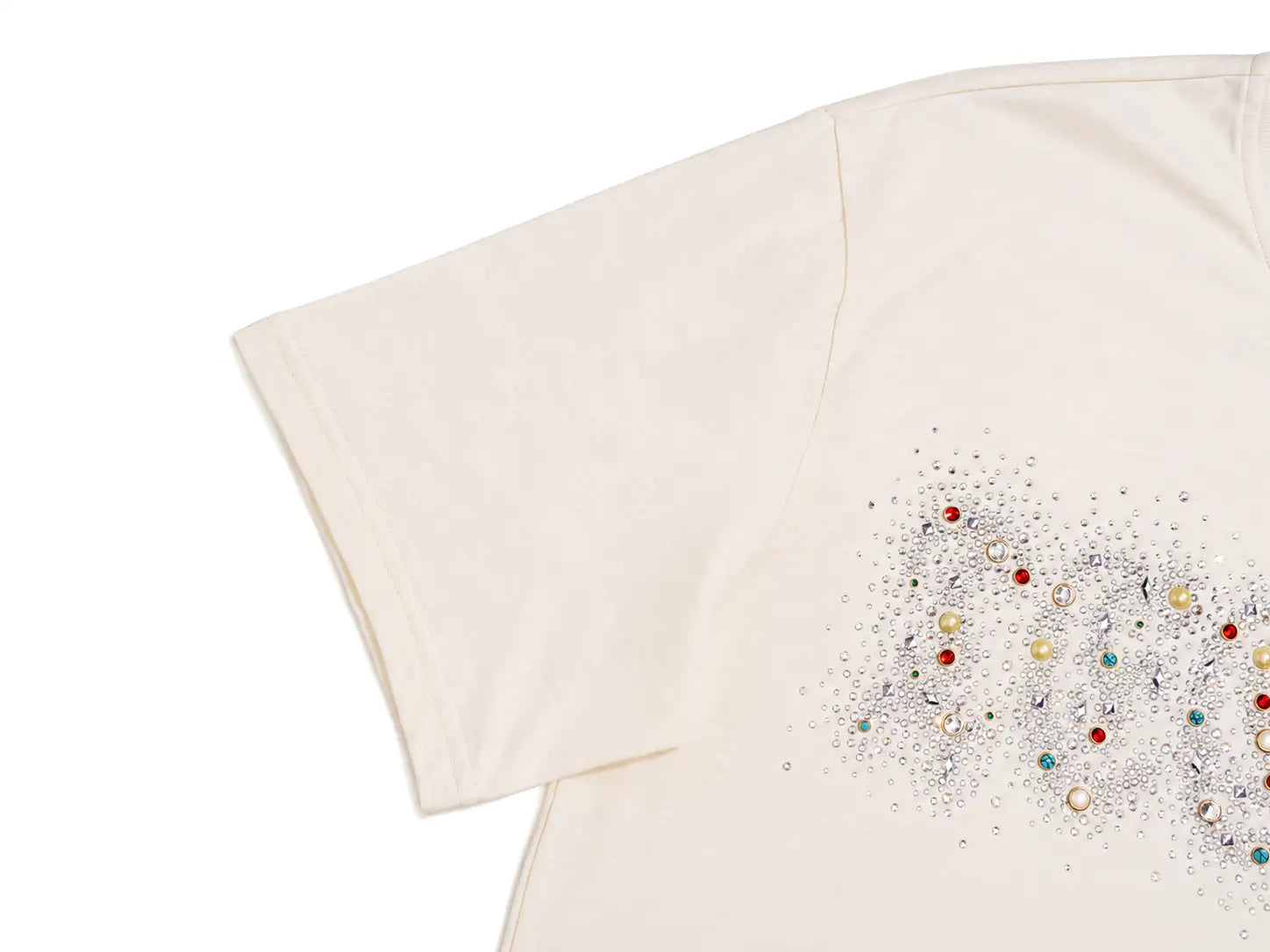 An off-white short-sleeve t-shirt featuring a decorative graphic on the right side composed of silver glitter, small pearls, and colorful rhinestones in red, green, and gold. TCH Rhinestone Sparkle Crystal Graphic White T-Shirt