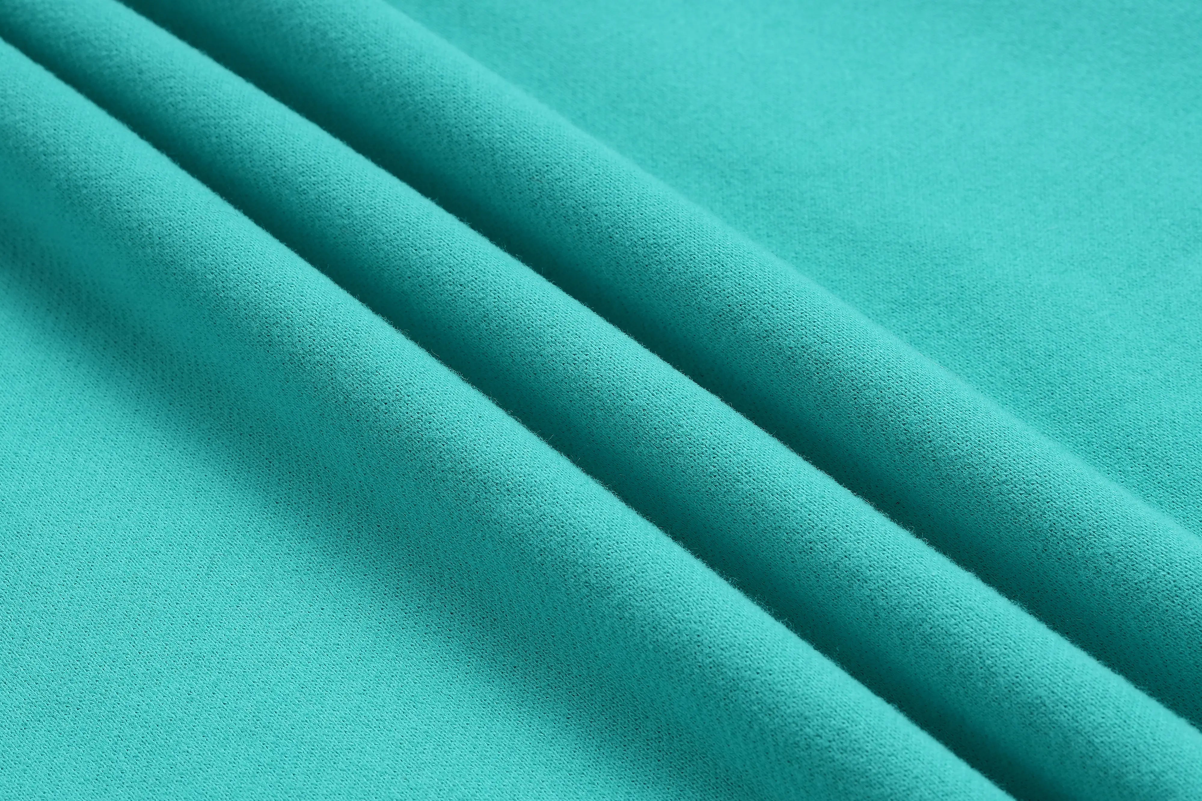 Close-up of teal fabric with folds, TCH Rhinestone “Tchmuch” Logo & Wings Teal Zip Tracksuit Set