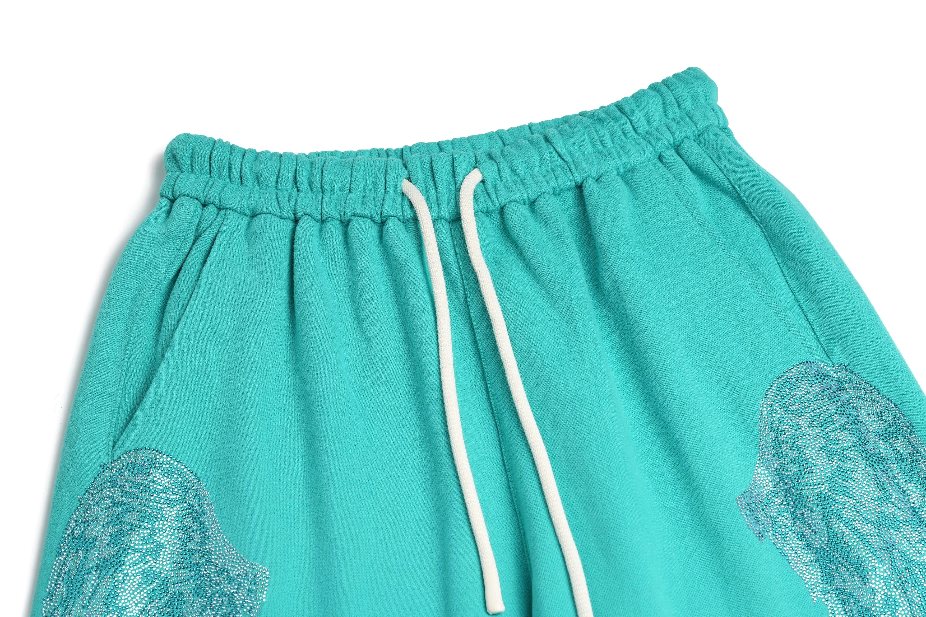 Teal shorts with lace detailing on a white background, TCH Rhinestone “Tchmuch” Logo & Wings Teal Zip Tracksuit Set