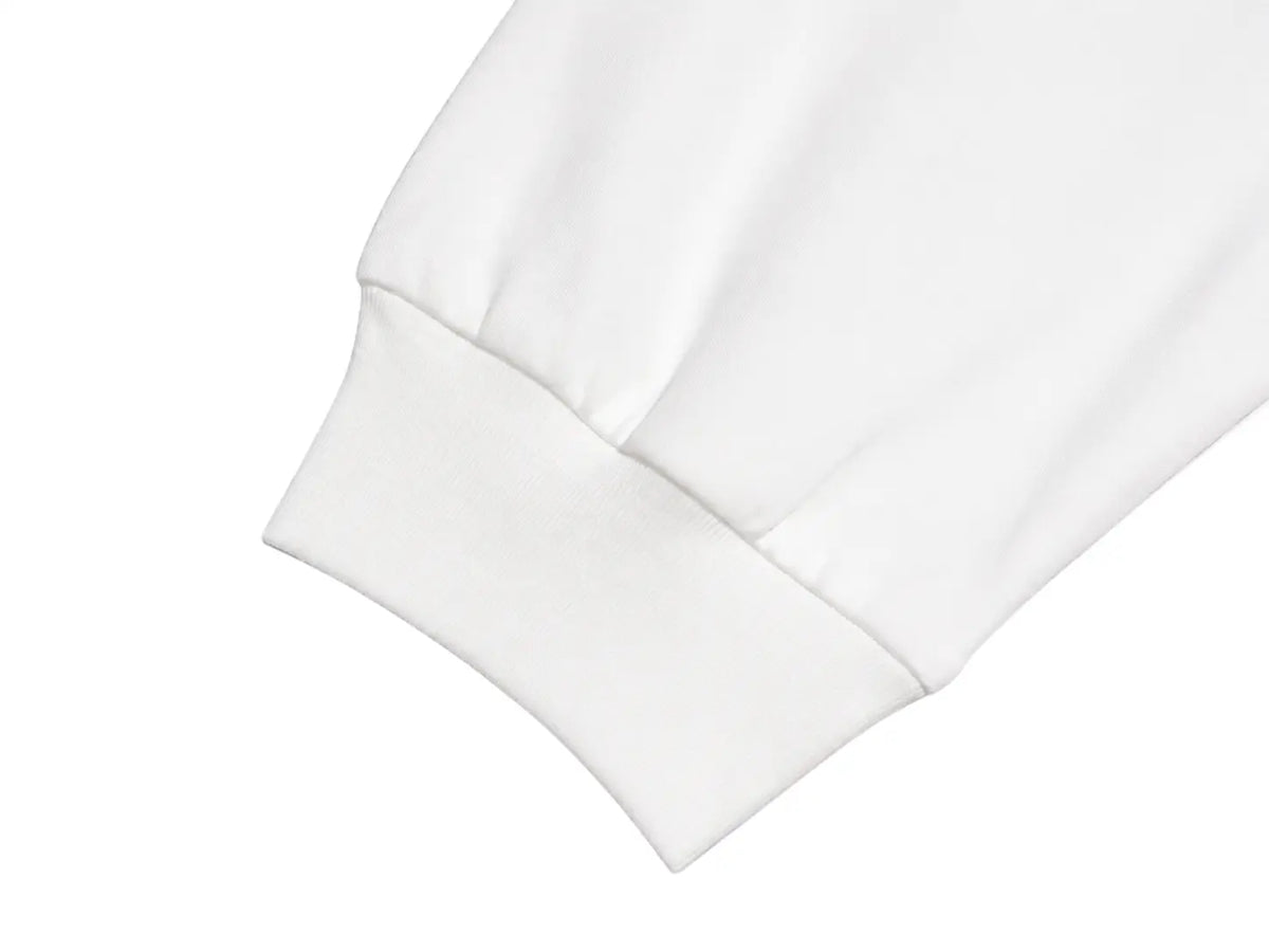 Close-up of a white ribbed cuff on a white garment, showing the fabric texture and stitching detail against a plain white background. TCH Rhinestone Teddy Bear Charm Graphic Long Sleeve Sweatshirt