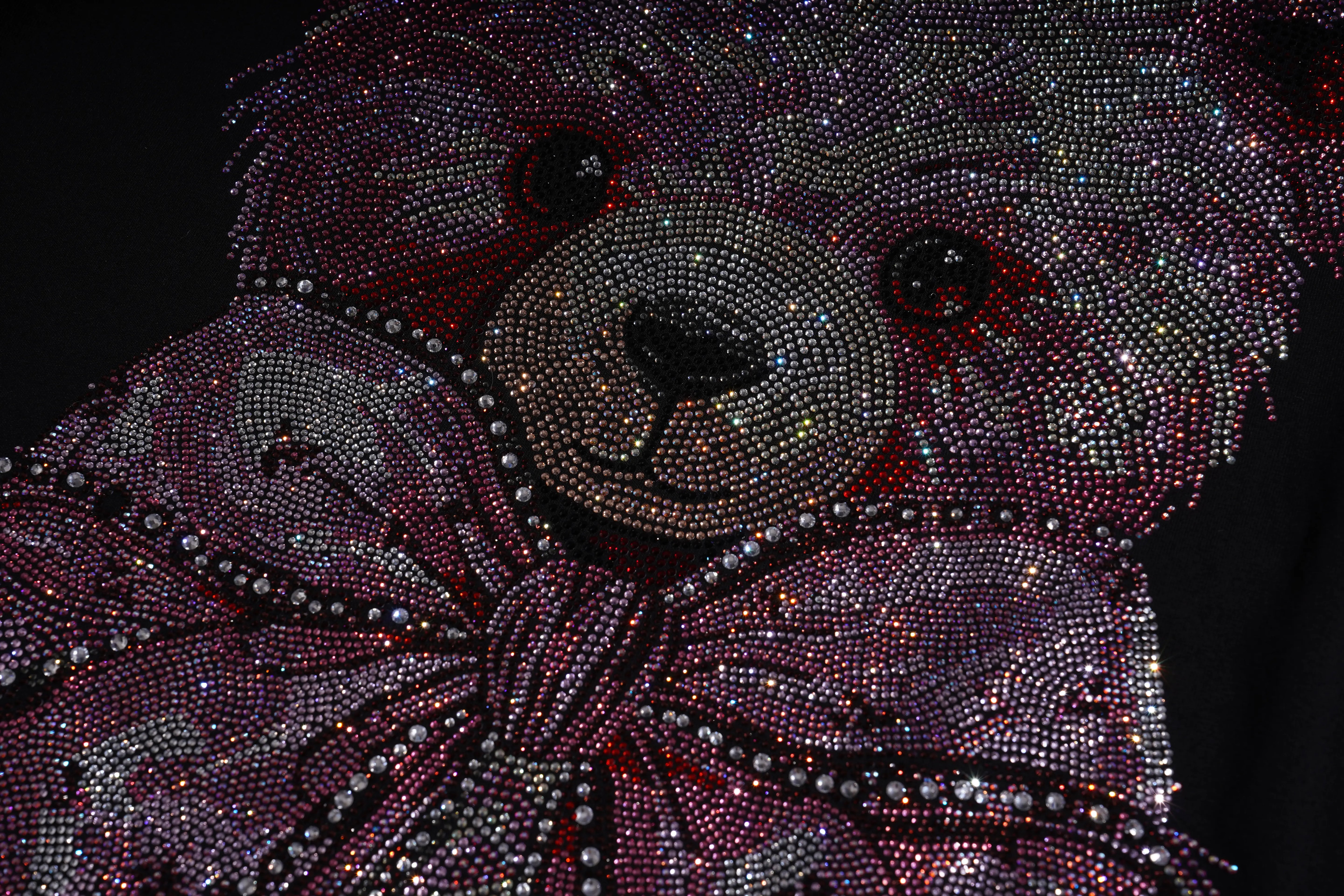 Teddy bear made of rhinestones on a dark background