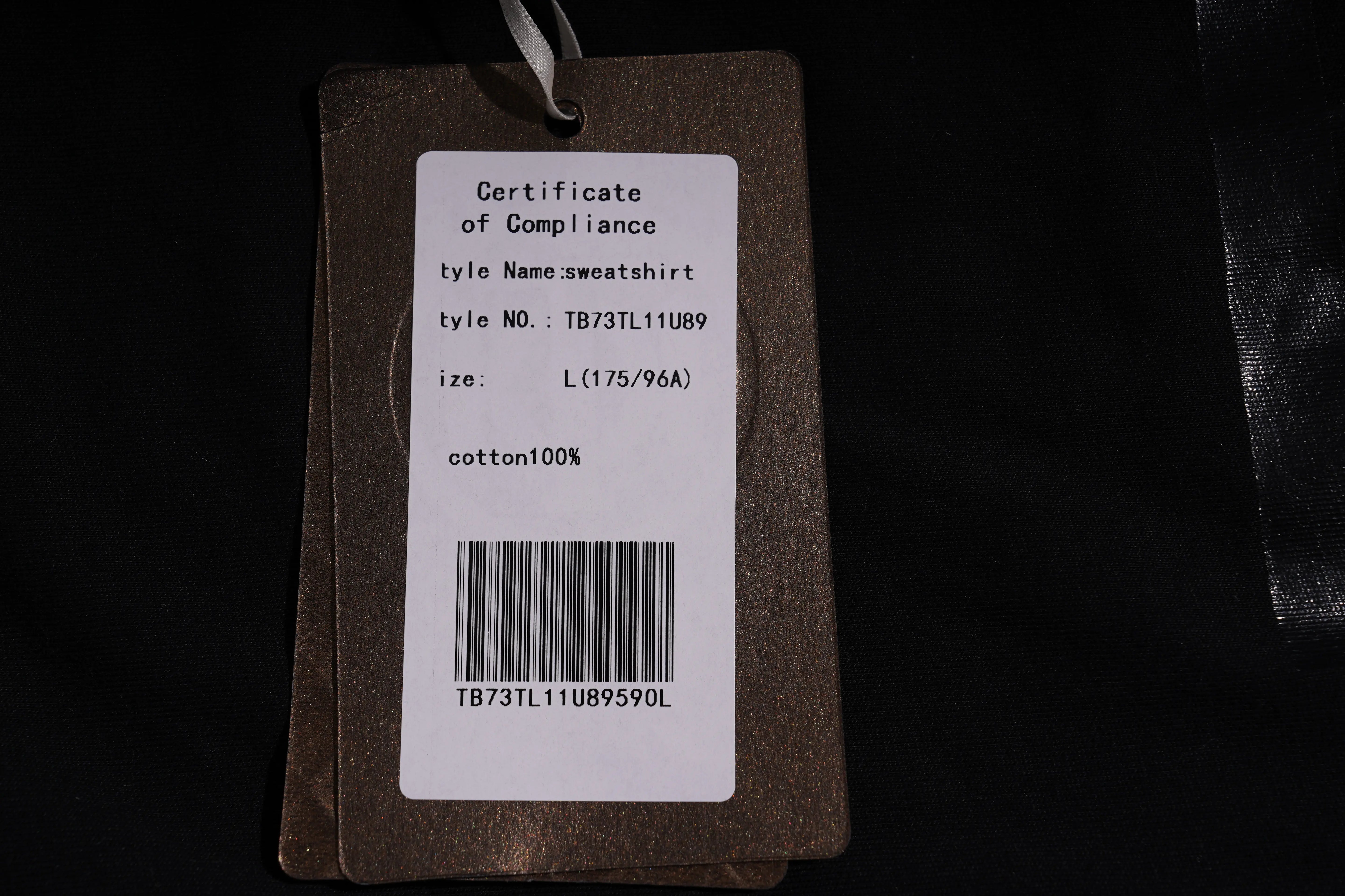 Clothing tag with product details on a black background