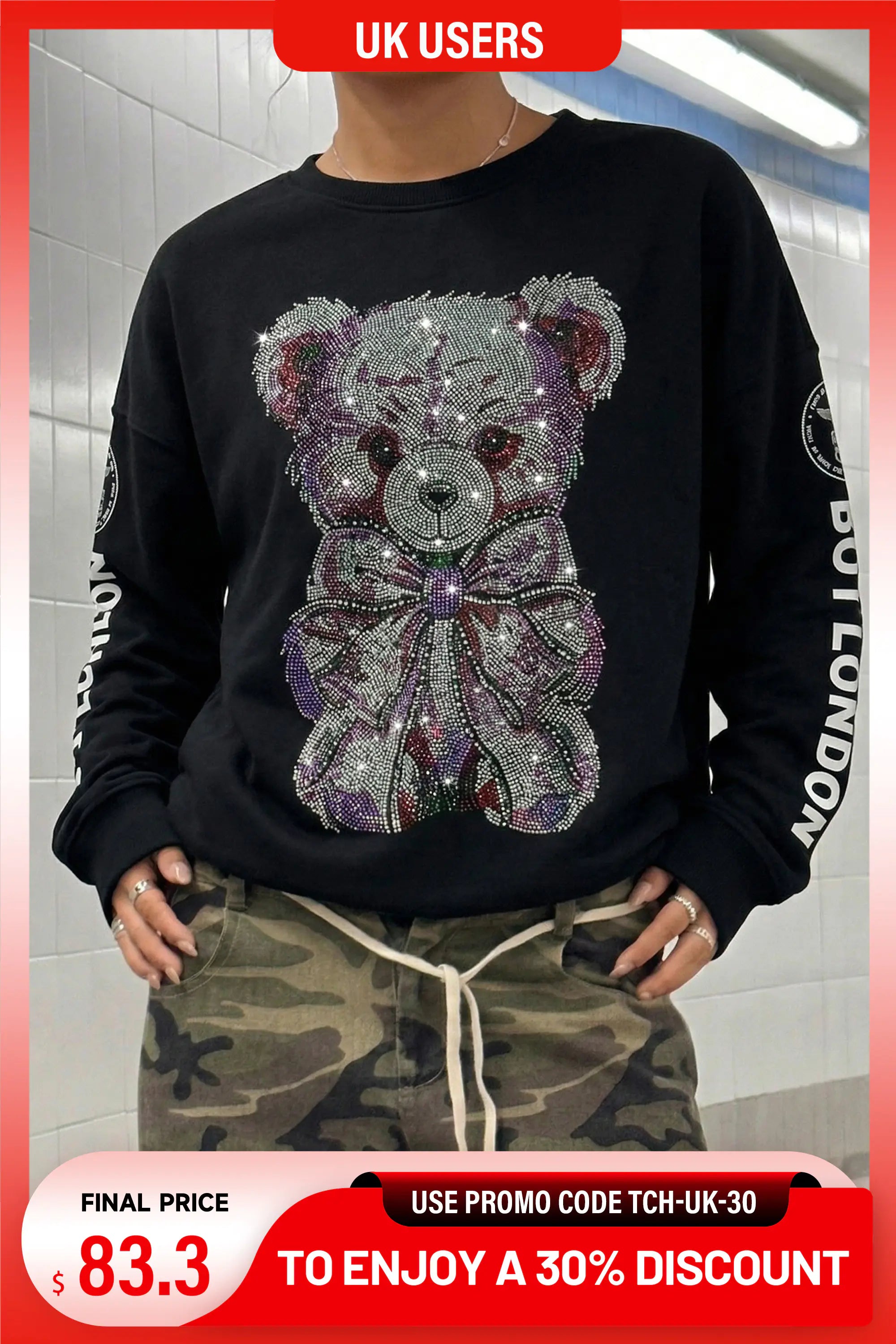 A person wearing a black crewneck sweatshirt with a large teddy bear face and bow design made of silver, purple, and pink rhinestones, paired with camouflage pants. The image has promotional overlays for 'UK USERS' and a discount code. TCH Rhinestone Teddy Bear Graphic Crewneck Sweatshirt
