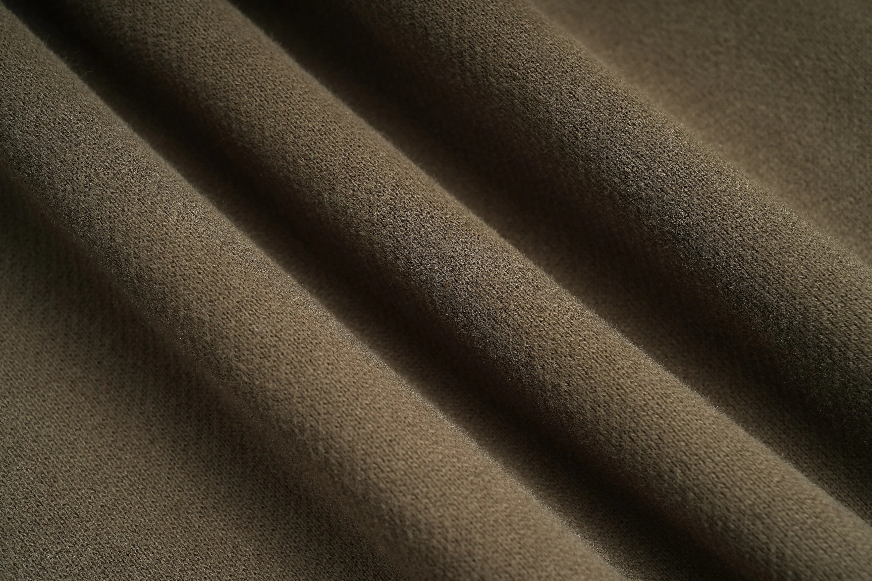 Close-up of brown fabric with visible texture, TCH Rhinestone Teddy Bear Military Green Zip Turtleneck Set