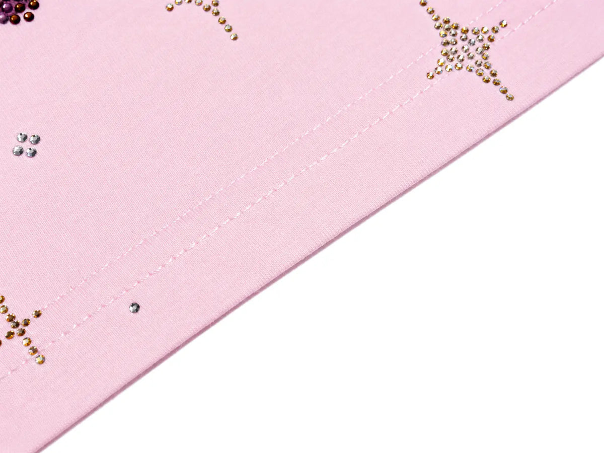 Close-up of a light pink fabric item with decorative gold rhinestone star and crescent motifs, shown against a white background. TCH Rhinestone Teddy Bear Pink Long Sleeve T-Shirt