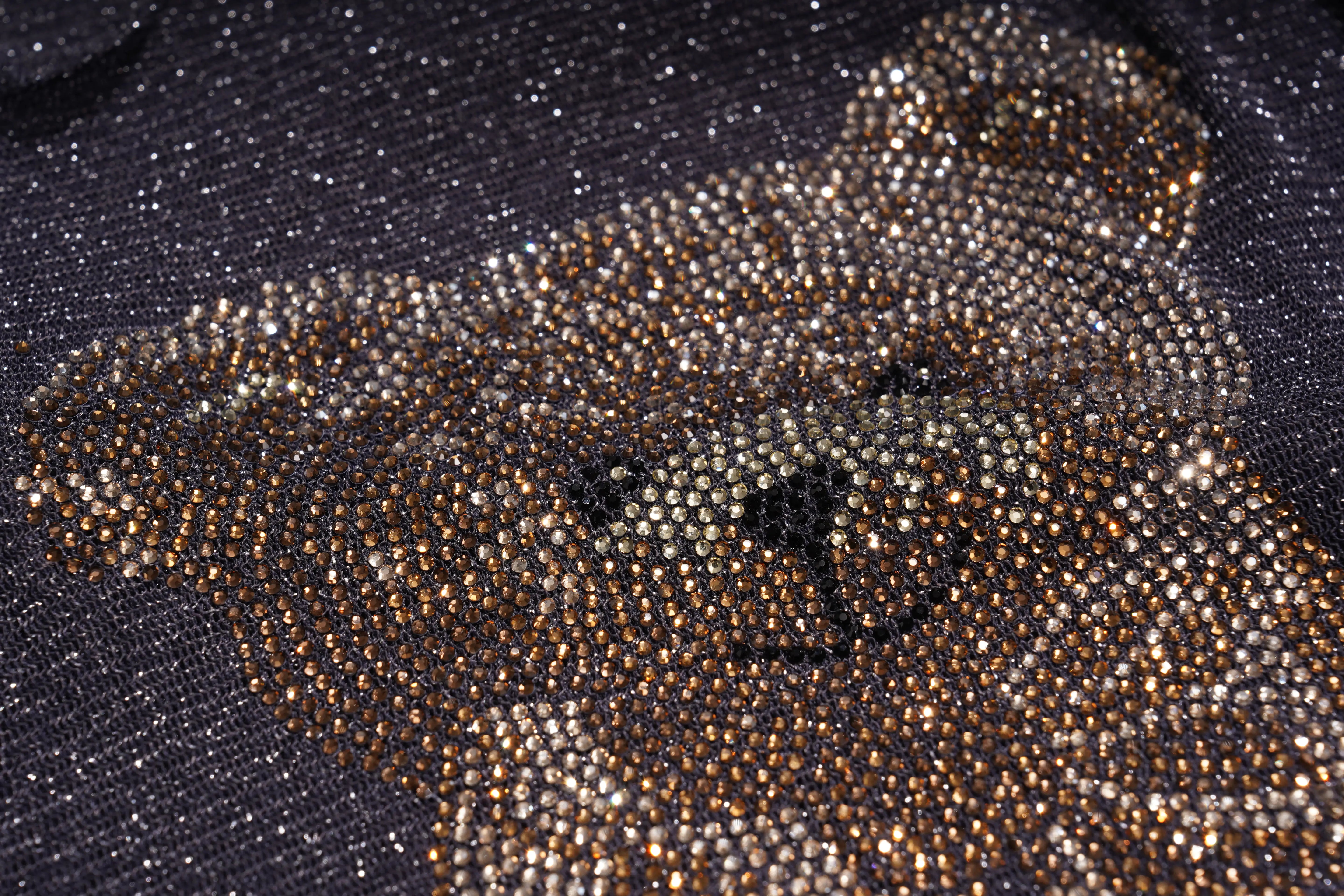 Close-up of a teddy bear face and upper body outlined with dense metallic rhinestones on a dark fabric background. TCH Rhinestone Teddy Bear Sheer Mesh Long Sleeve Top
