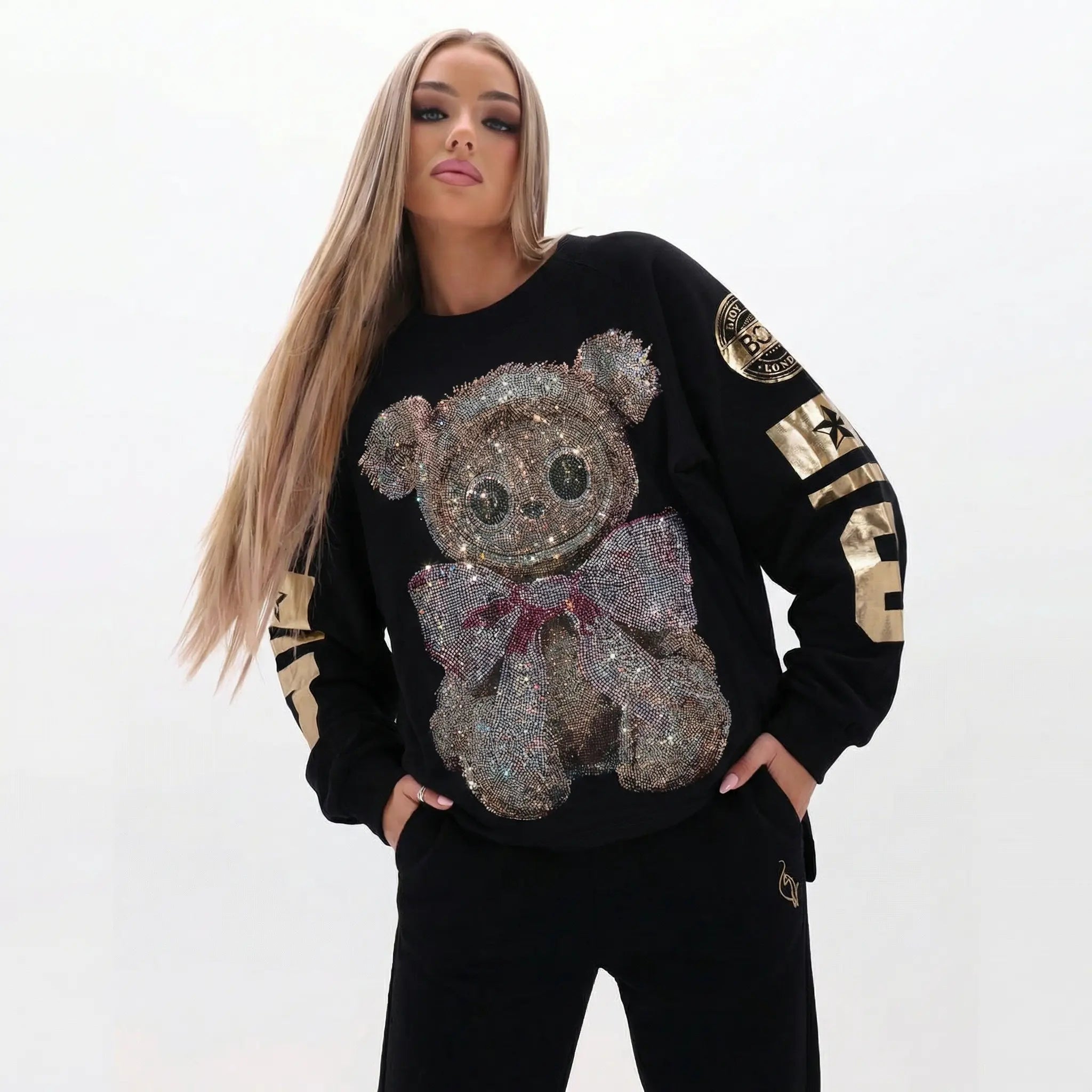 Woman wearing a black sweater with a sequined bear design on a white background, TCH Rhinestone Teddy Bear Sweatshirt