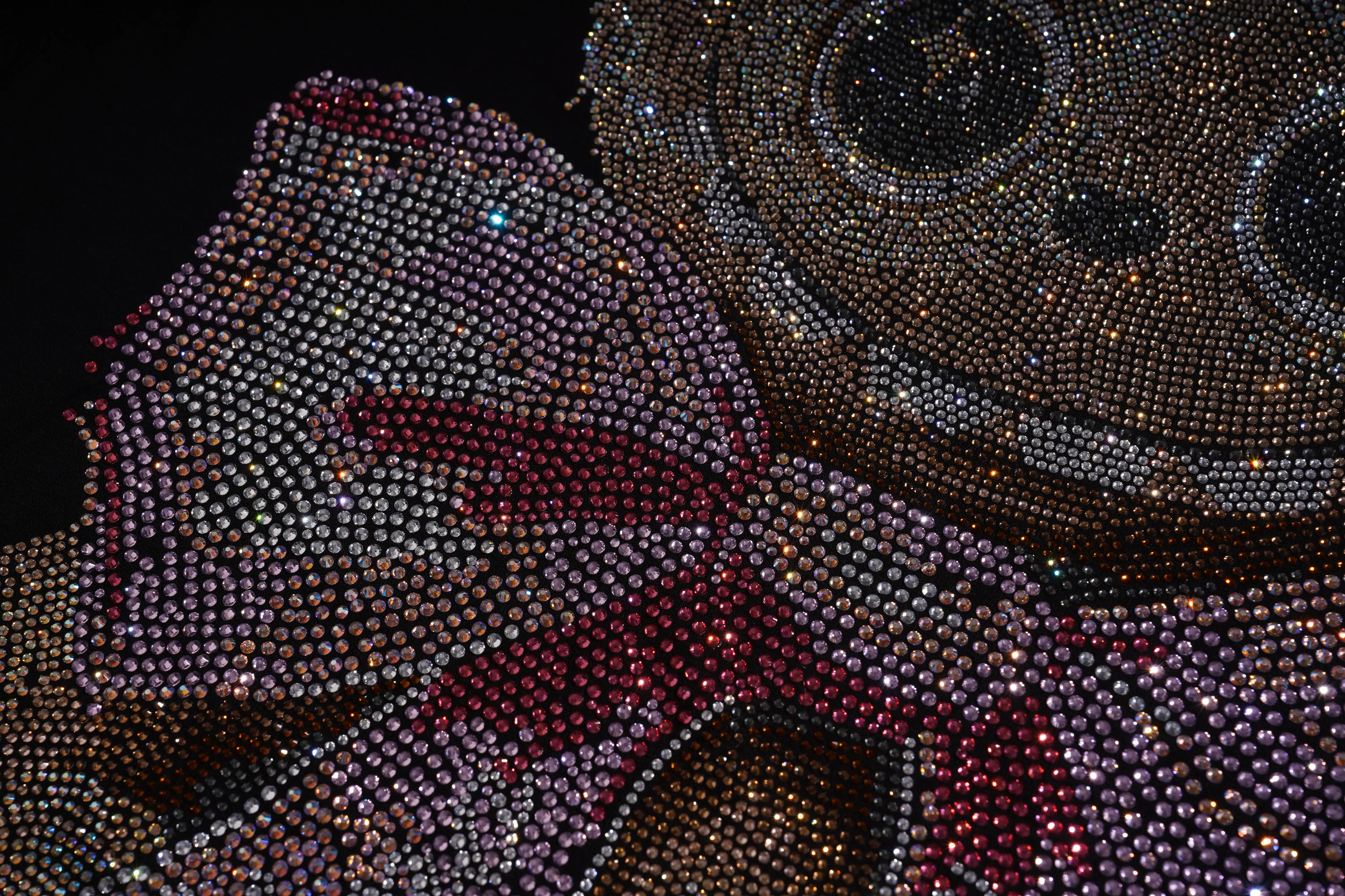 Close-up of a decorative item with a bow made of small beads on a dark background, TCH Rhinestone Teddy Bear Sweatshirt