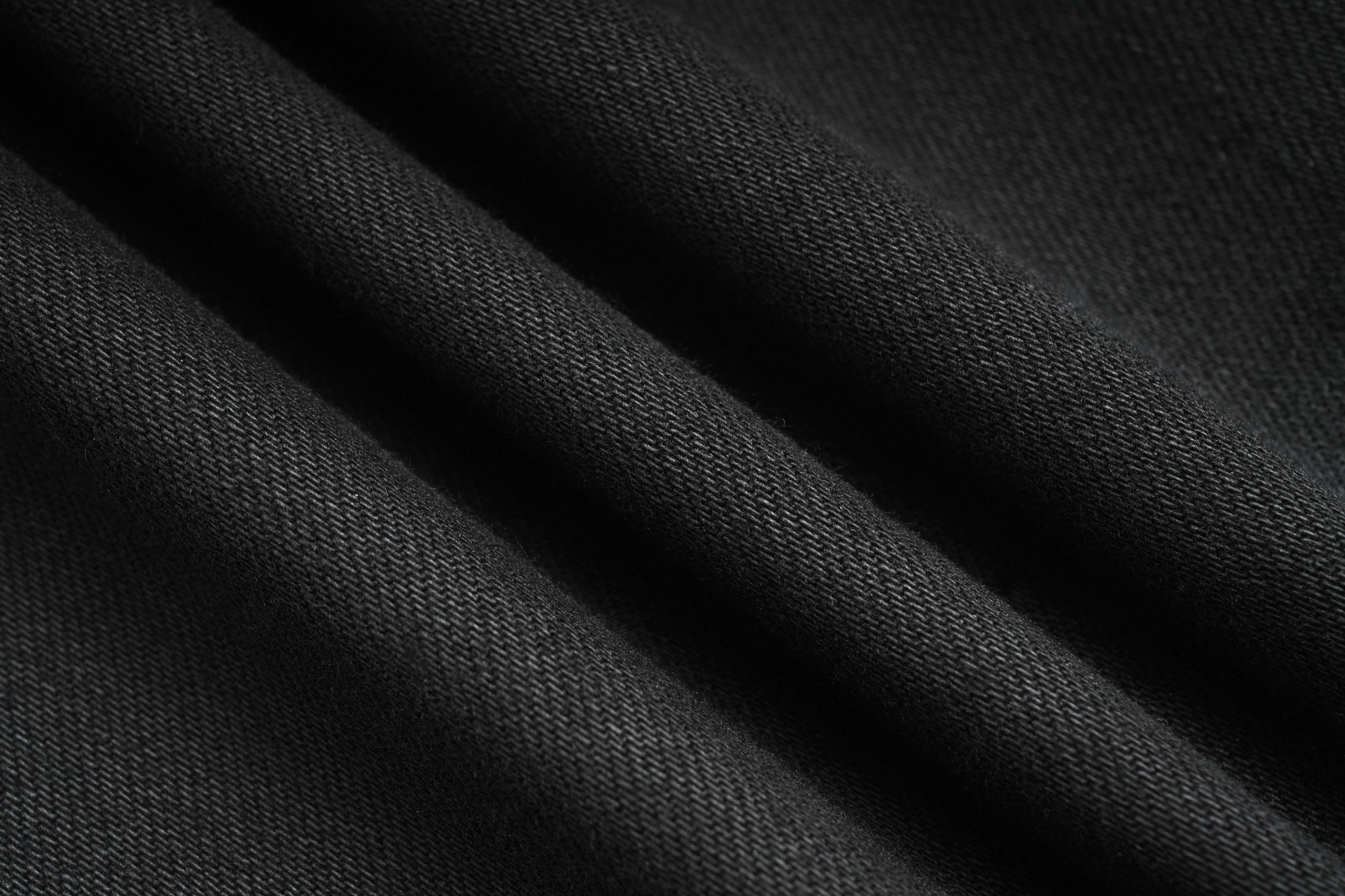 Close-up of black fabric texture, TCH Rhinestone Teddy Bear & Techno Black Denim Jeans