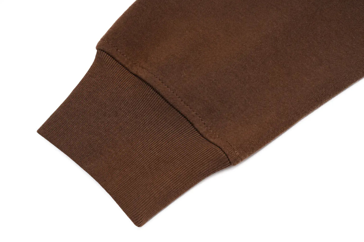 Close-up of a brown ribbed knit cuff on a matching brown garment, shown against a plain white background. TCH Rhinestone Teddy Bear Techno Sweatshirt Dress