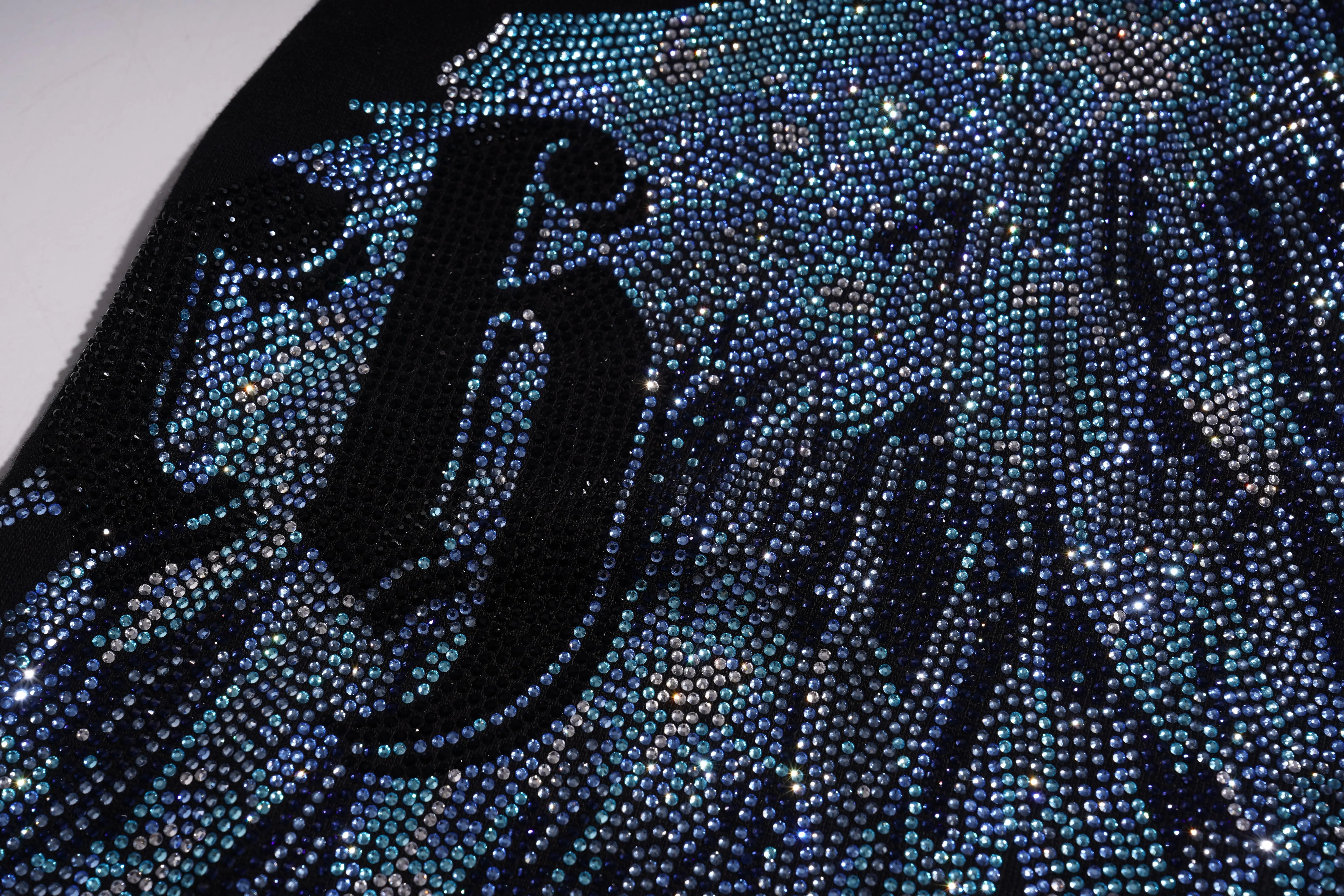 Close-up of a black and blue rhinestone design on a plain background, TCH Rhinestone Wing Black Crewneck Sweatshirt
