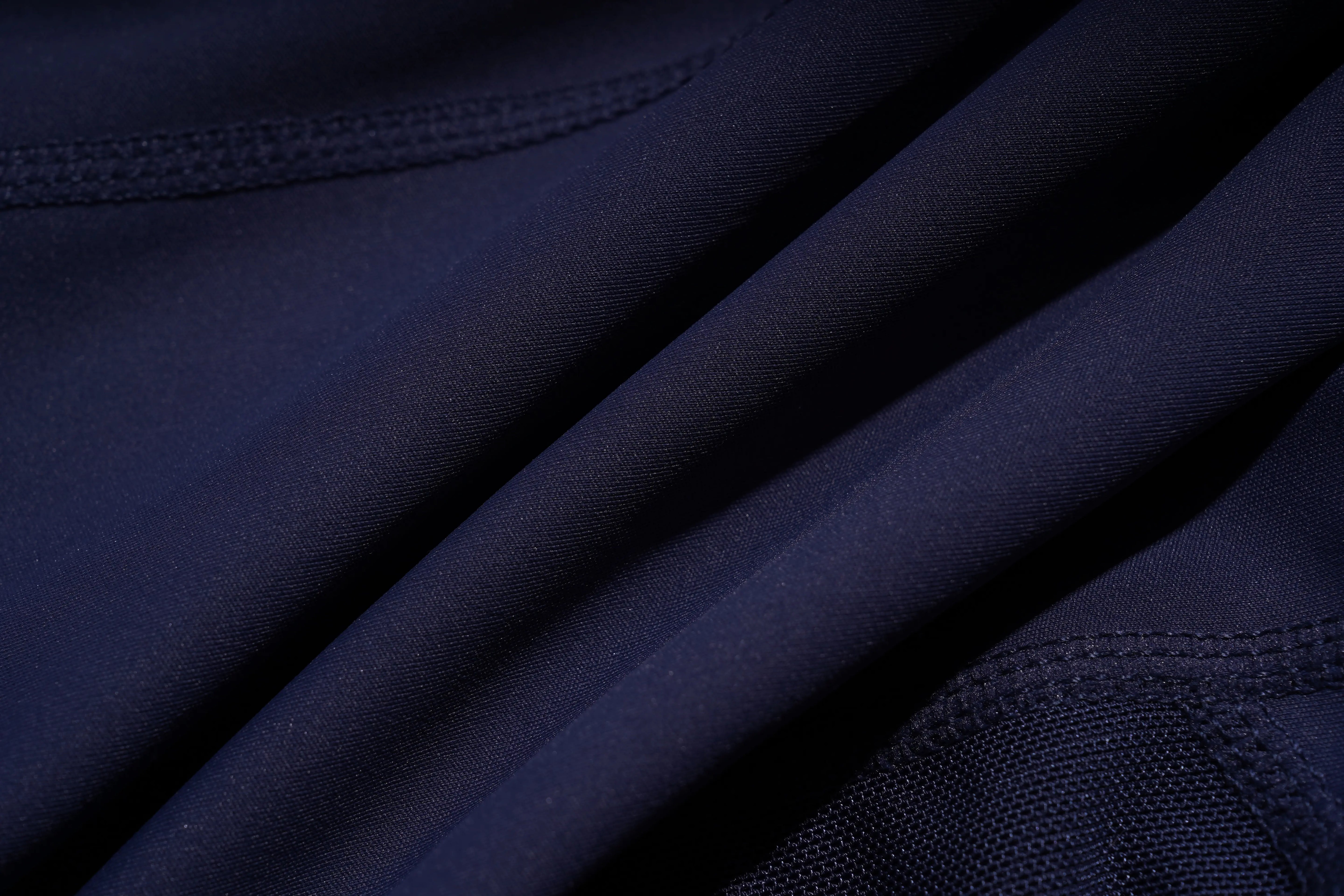 Close-up of dark blue fabric with a textured pattern