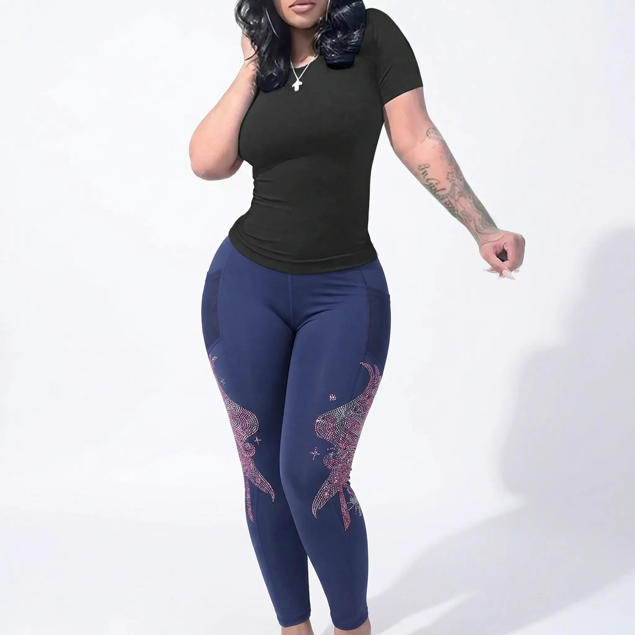 Person wearing navy leggings with pink designs on a white background, TCH Rhinestone Wing Graphic High-Waist Leggings