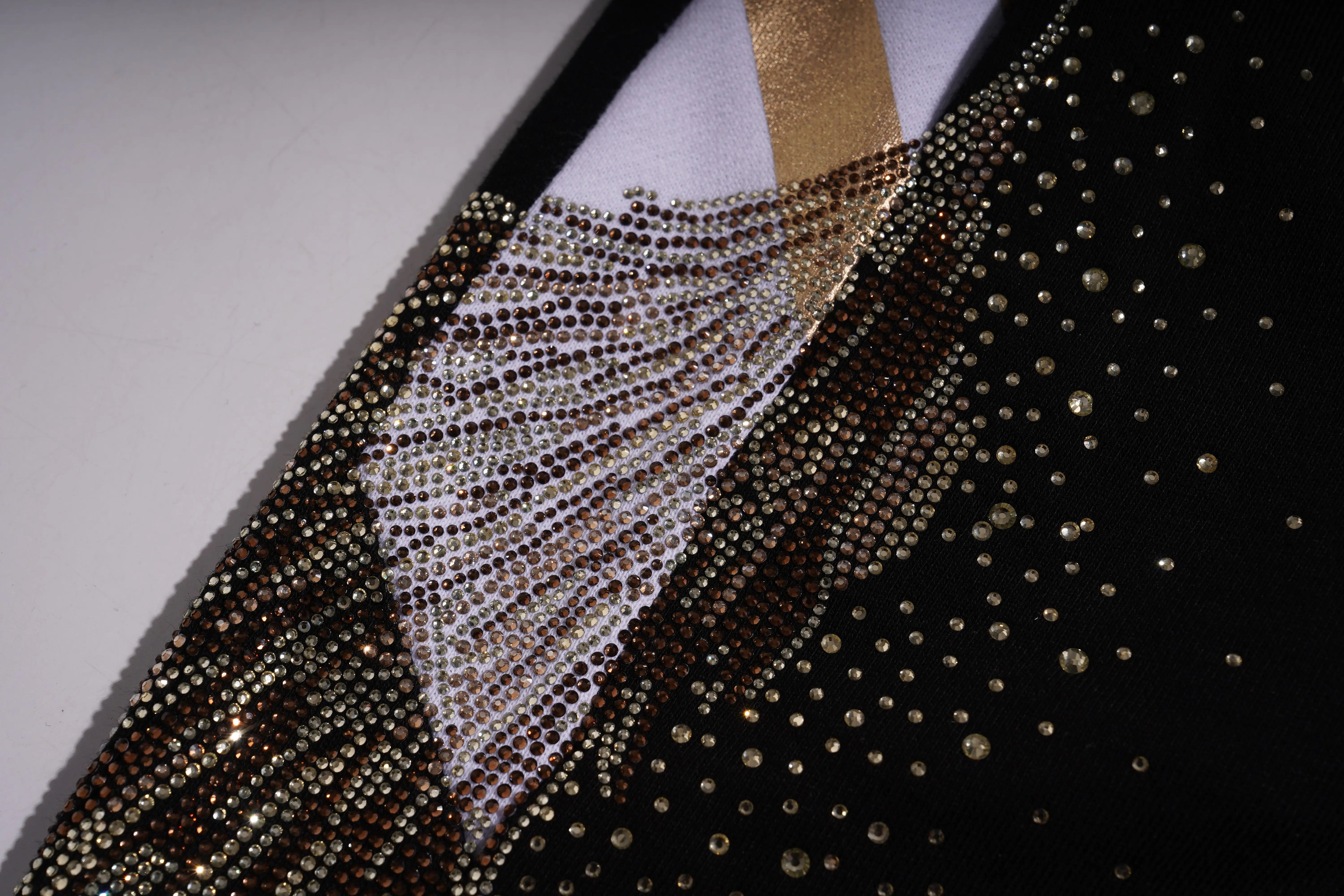 Close-up of a black garment with gold embellishments on a plain background, TCH Rhinestone Wing Techno Jogger Pants