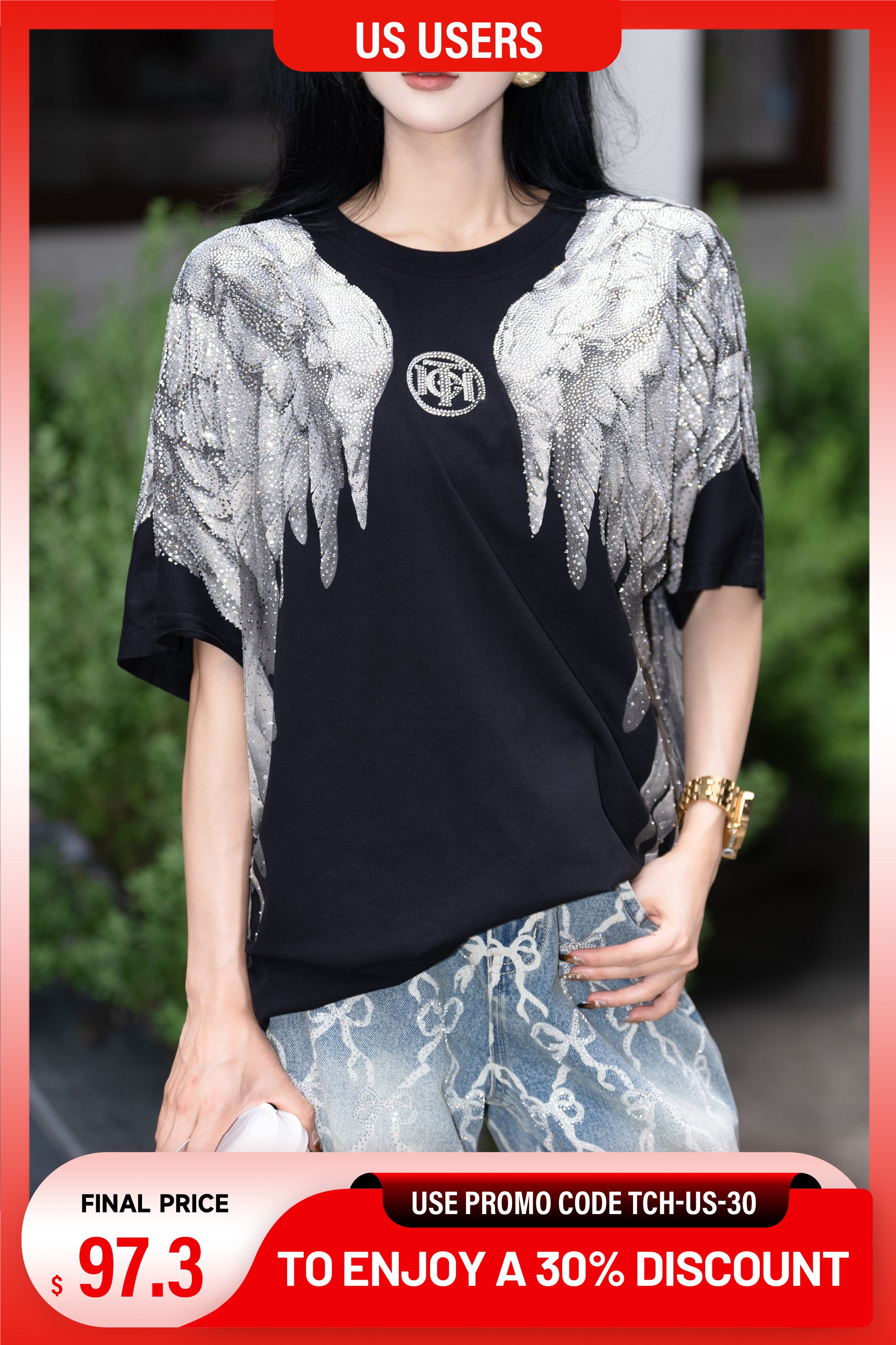 Woman wearing a black t-shirt with silver angel wings design, standing outdoors. TCH Rhinestone Wings Logo Black Graphic T-Shirt