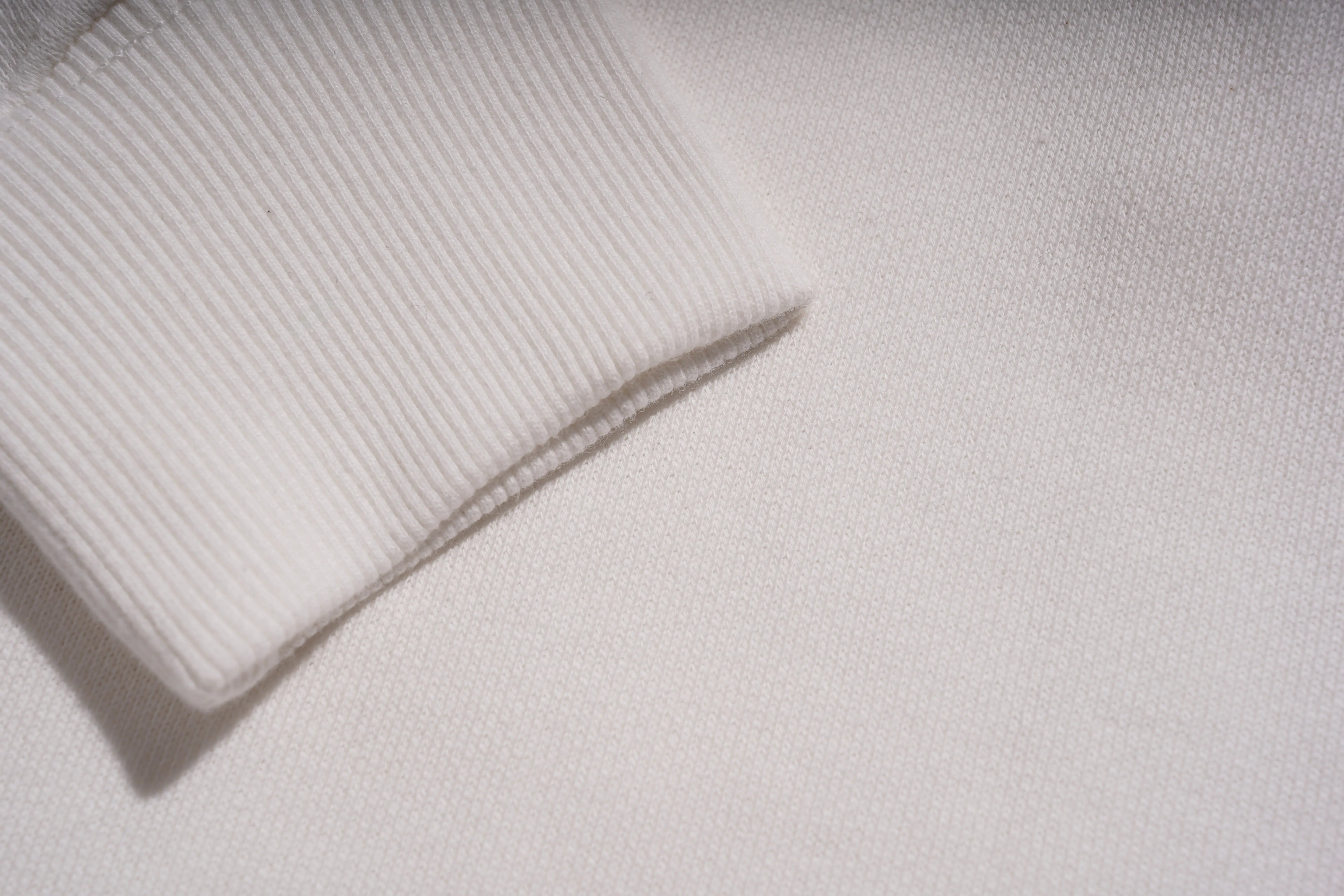 Close-up of a textured white fabric surface, TCH Rhinestone Winter Lamb Sweatshirt