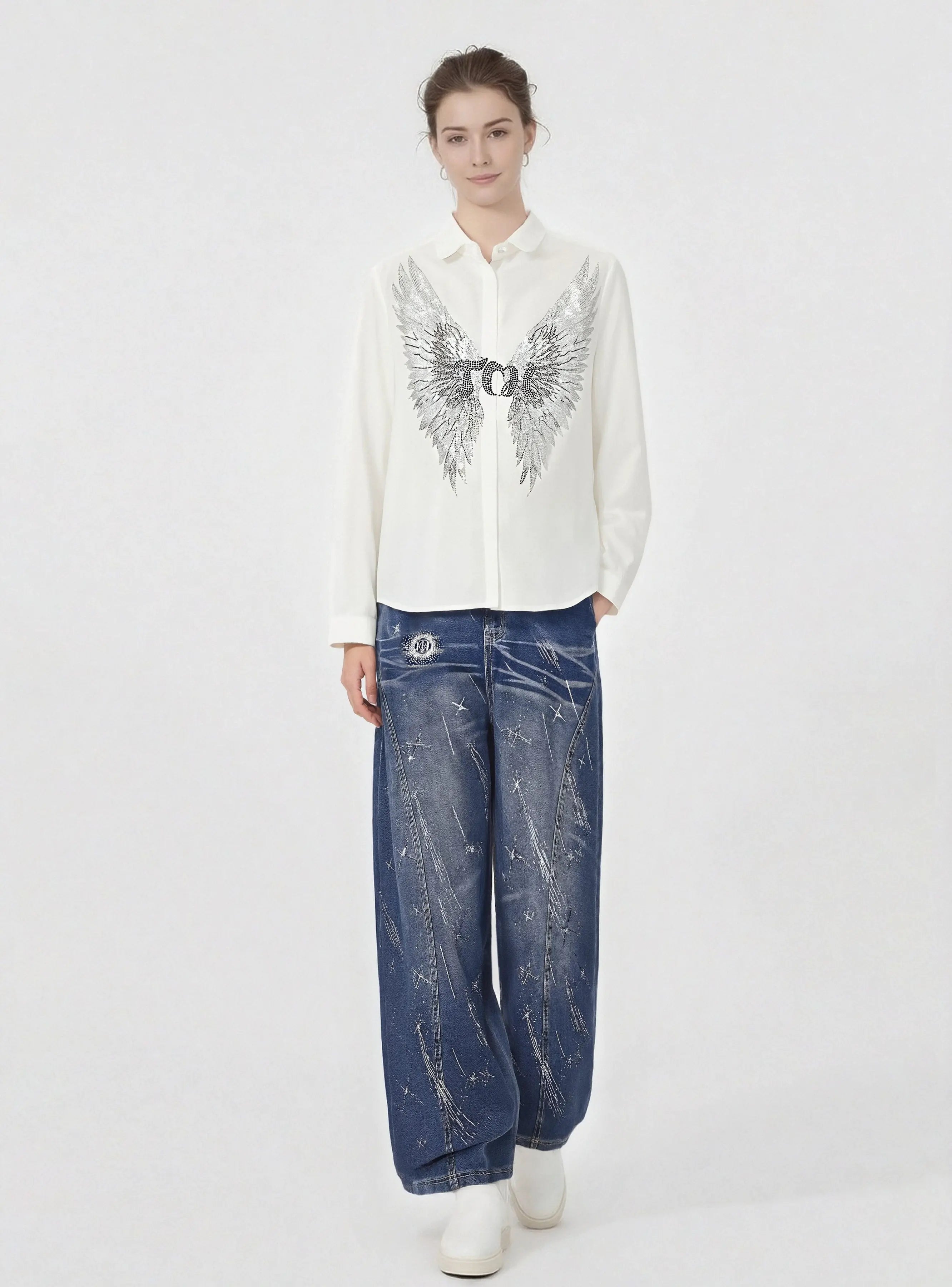 Person wearing a white shirt with a graphic design and blue jeans on a white background, TCH Shooting Star Rhinestone Wide-Leg Blue Jeans