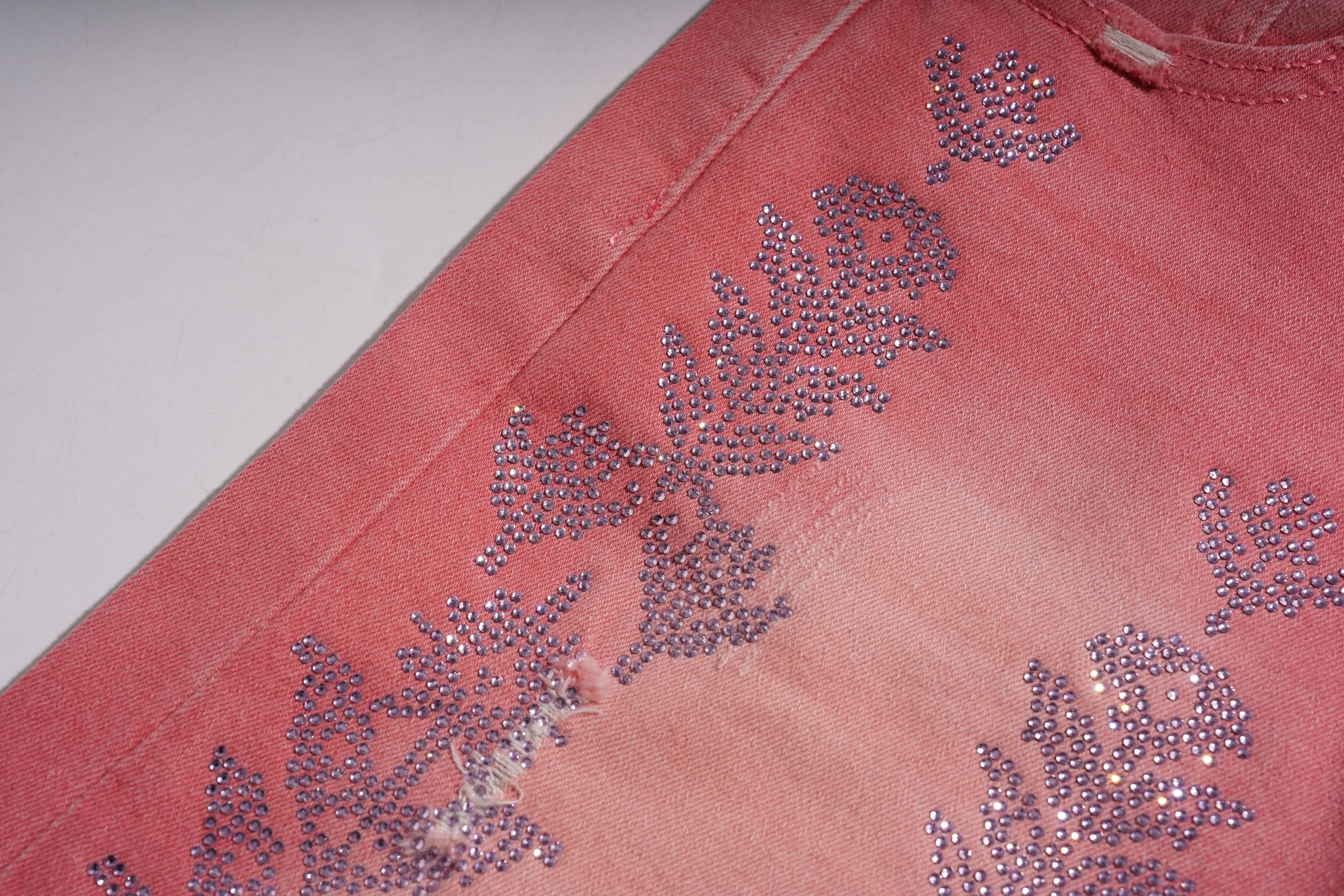 Pink fabric with floral embellishments made of small crystals on a white background, TCH Silver Bouquet Rhinestone Pink Denim Jeans