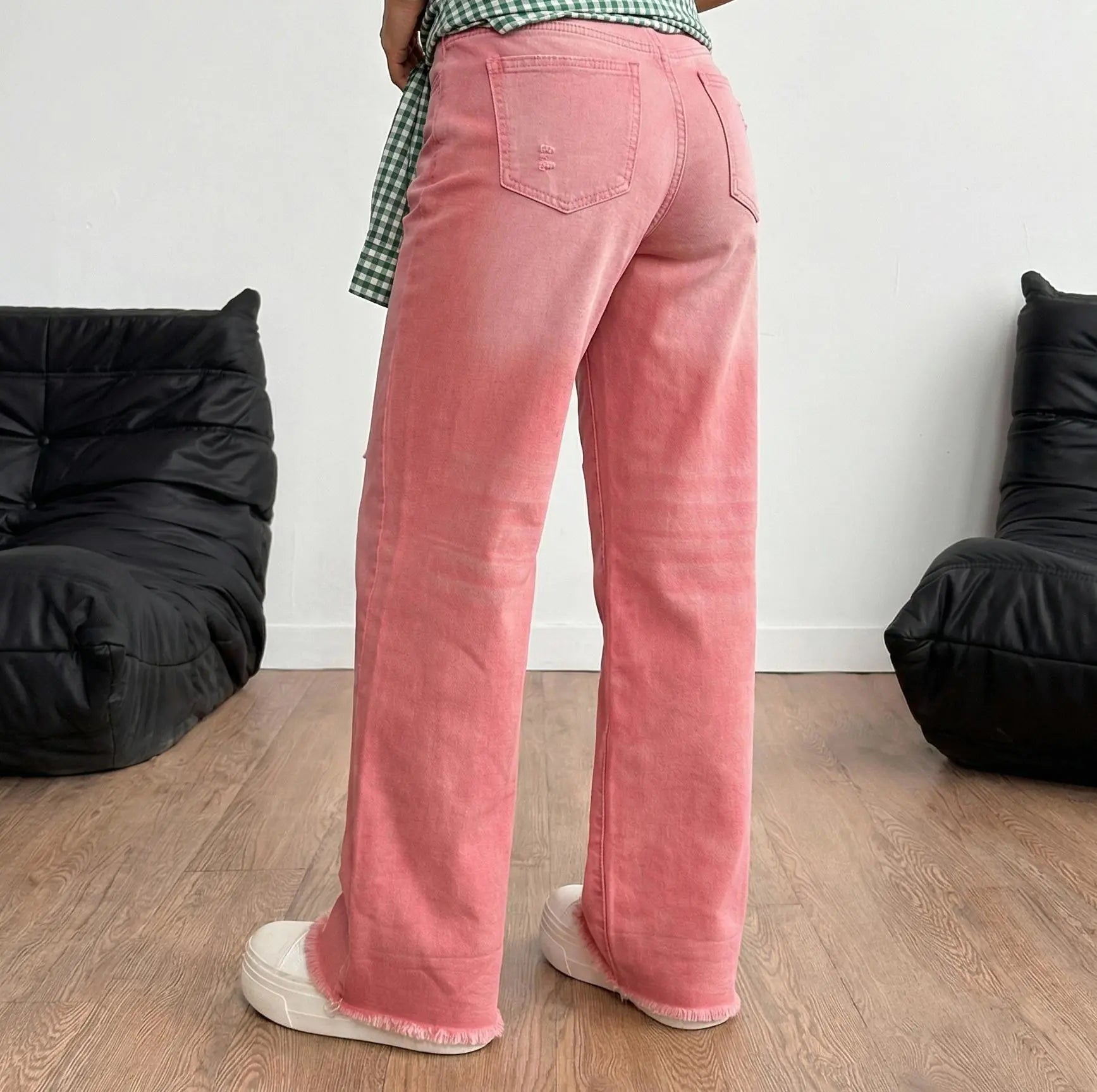 Person wearing pink pants standing in a room with black bean bags and a white wall. TCH Silver Bouquet Rhinestone Pink Denim Jeans