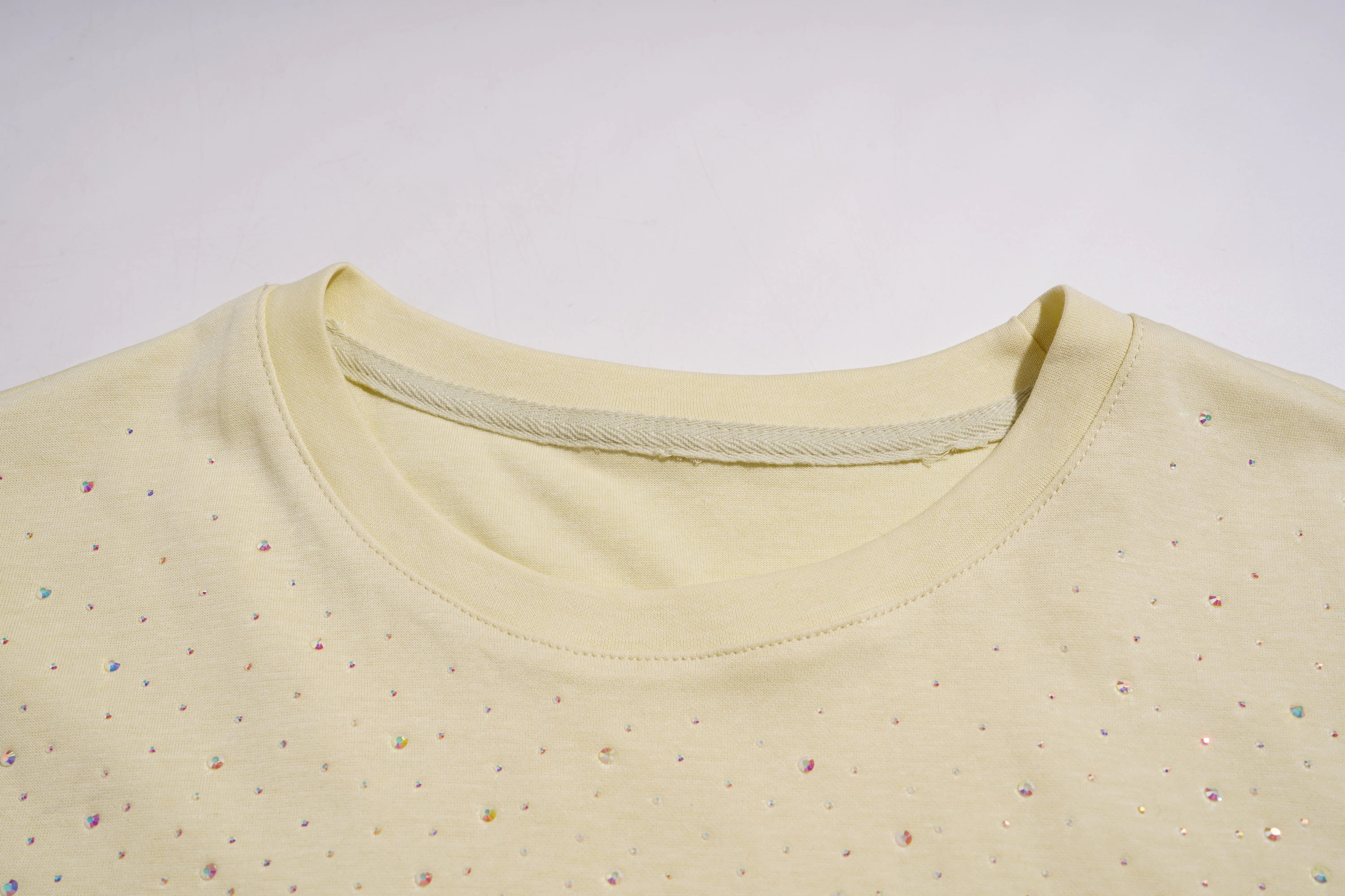 Close-up of a yellow shirt with small colorful dots on a white background, TCH Starry Gradient Rhinestone Butterfly T-Shirt