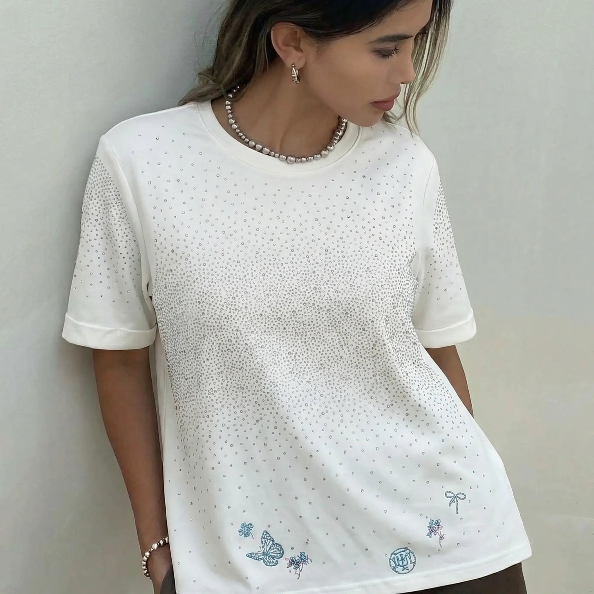 Woman wearing a white t-shirt with blue designs against a plain background, TCH Starry Gradient Rhinestone Butterfly T-Shirt
